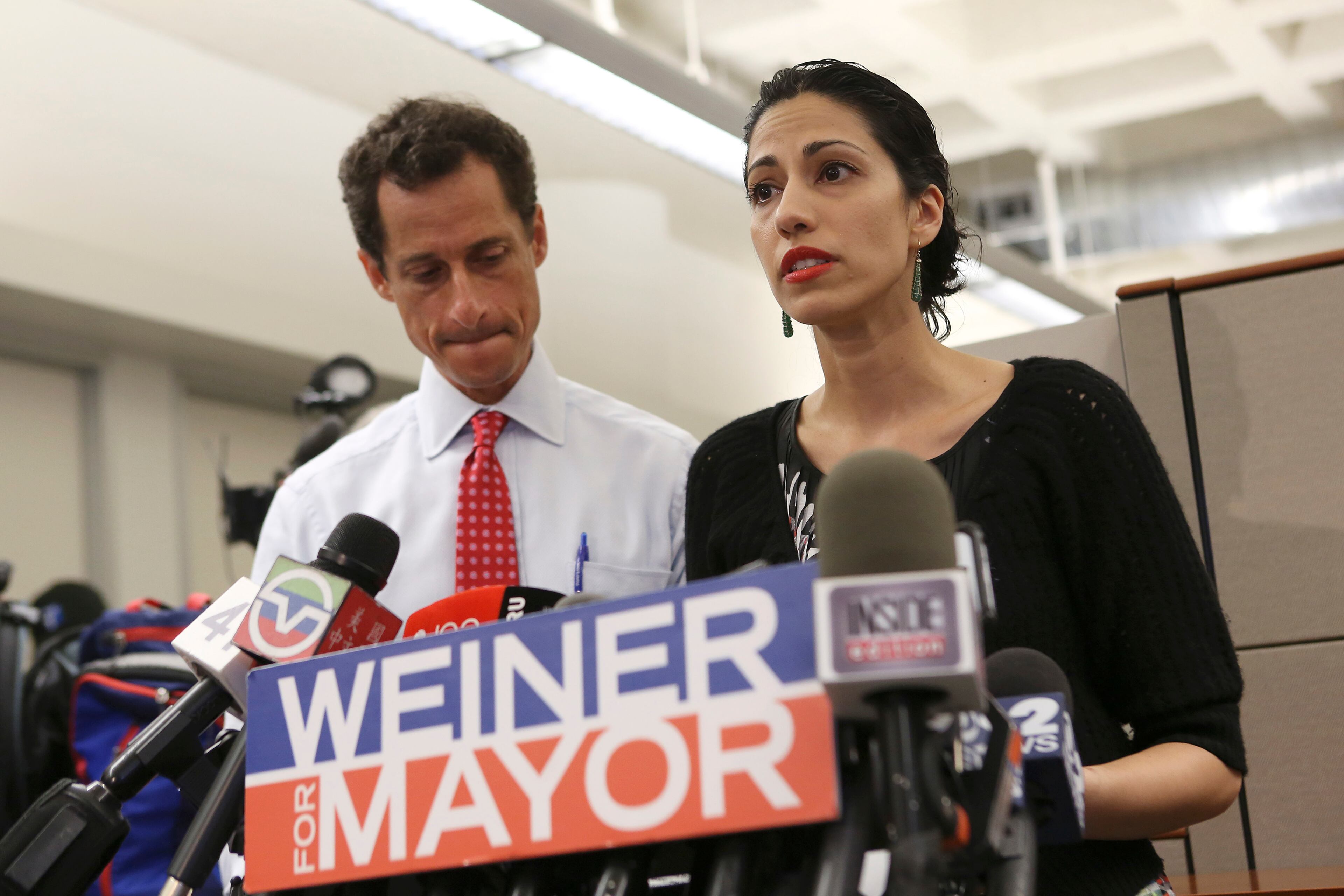 Former Rep. Anthony Weiner, a former New York City mayoral candidate, listens as his wife, Huma Abedin, speaks at a news conference. In her new memoir, “Both/And: A Life in Many Worlds,” Abedin opens up about her ex-husband, the 2016 election and more. (Michael Appleton/The New York Times)