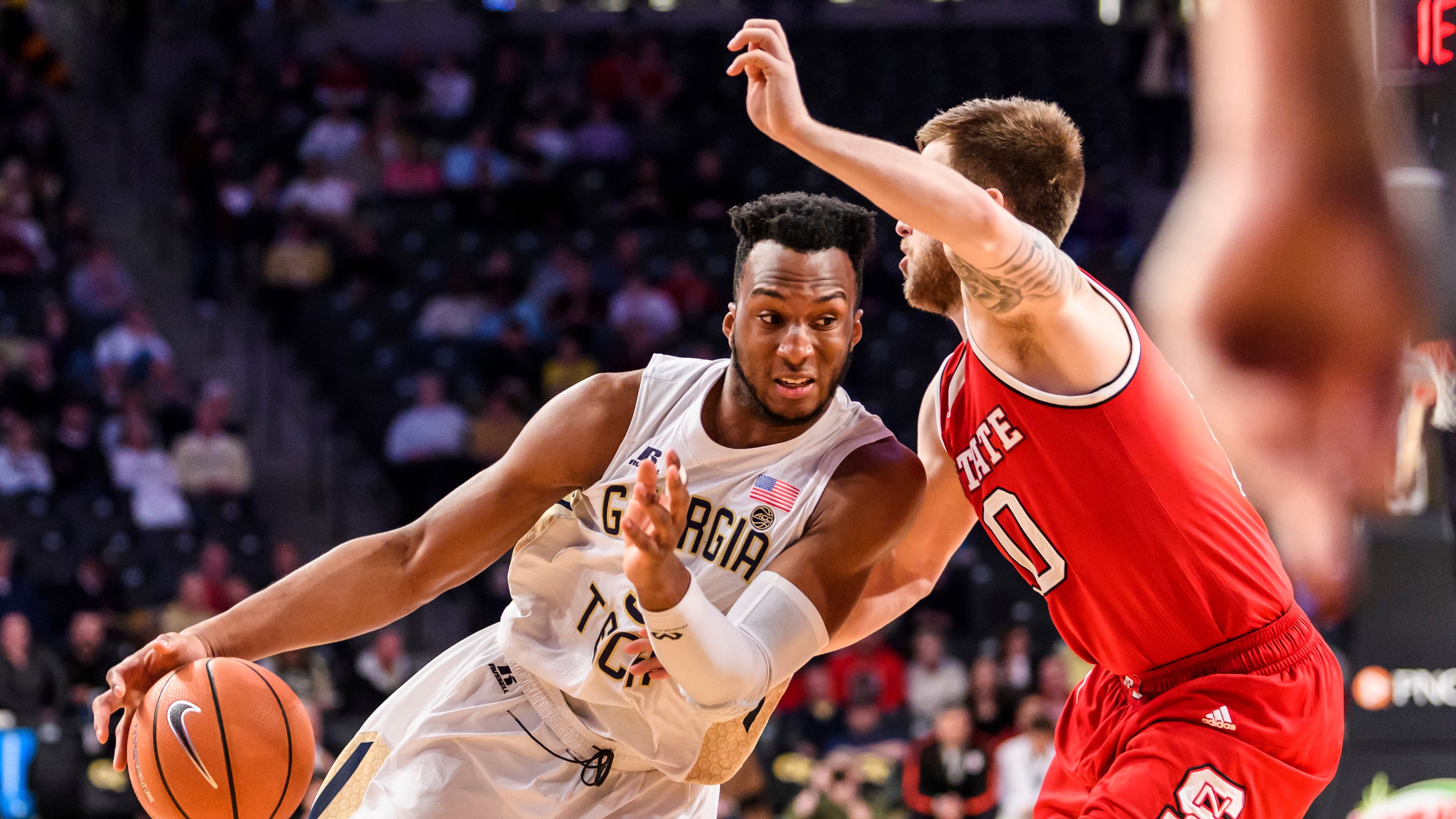 Georgia Tech guard Josh Okogie, left, drives to the basket as North Carolina State guard Braxton Beverly defends in the first half of an NCAA college basketball game, in Atlanta, Thursday, March 1, 2018. (AP Photo/Danny Karnik)