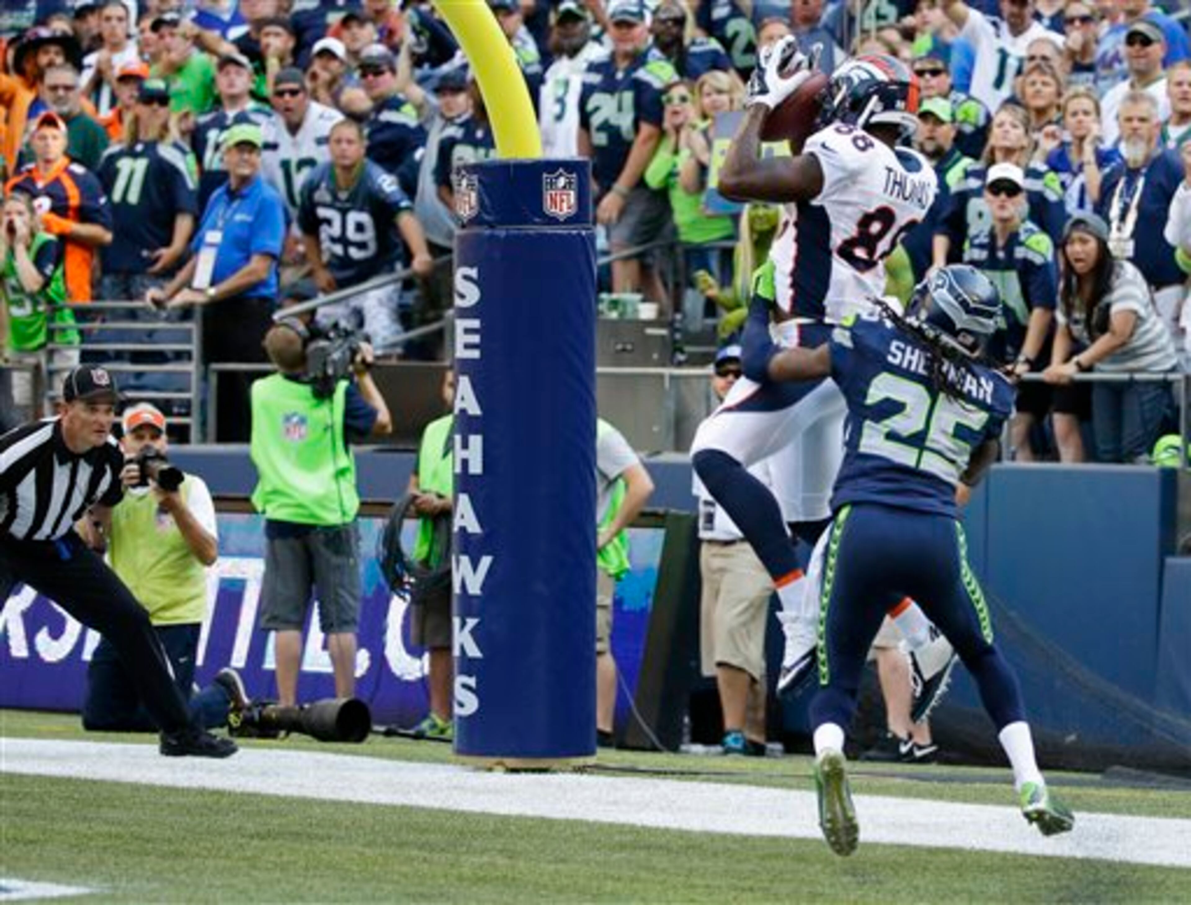Denver Broncos wide receiver Demaryius Thomas (88) ties the game with a catch on a 2-point conversion as Seattle Seahawks cornerback Richard Sherman (25) defends in the second half of an NFL football game, Sunday, Sept. 21, 2014, in Seattle. (AP Photo/Elaine Thompson)