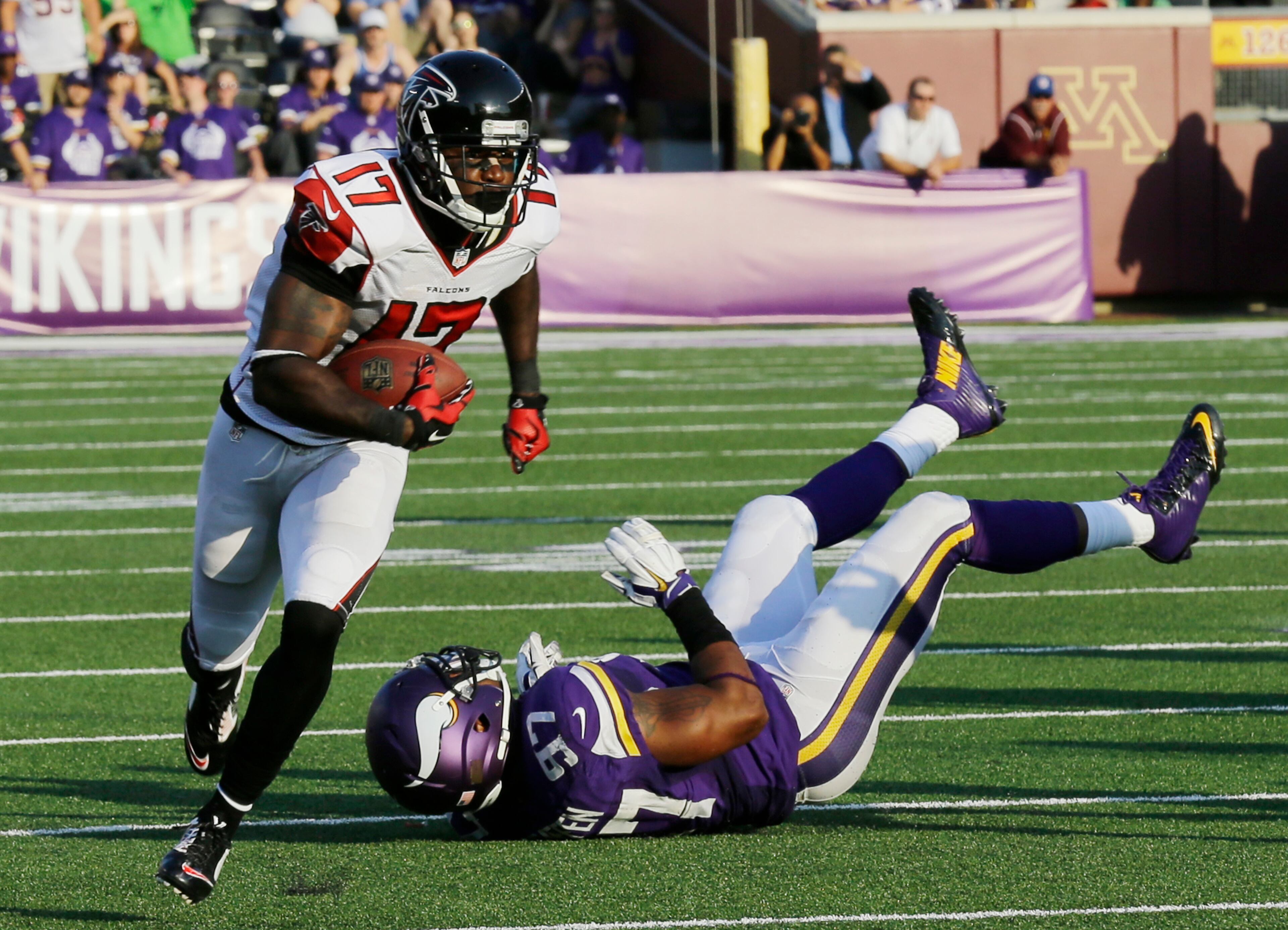 Atlanta Falcons wide receiver Devin Hester (17) runs from Minnesota Vikings defensive end Everson Griffen (97) during 36-yard touchdown reception in the second half of an NFL football game, Sunday, Sept. 28, 2014, in Minneapolis. (AP Photo/Ann Heisenfelt)