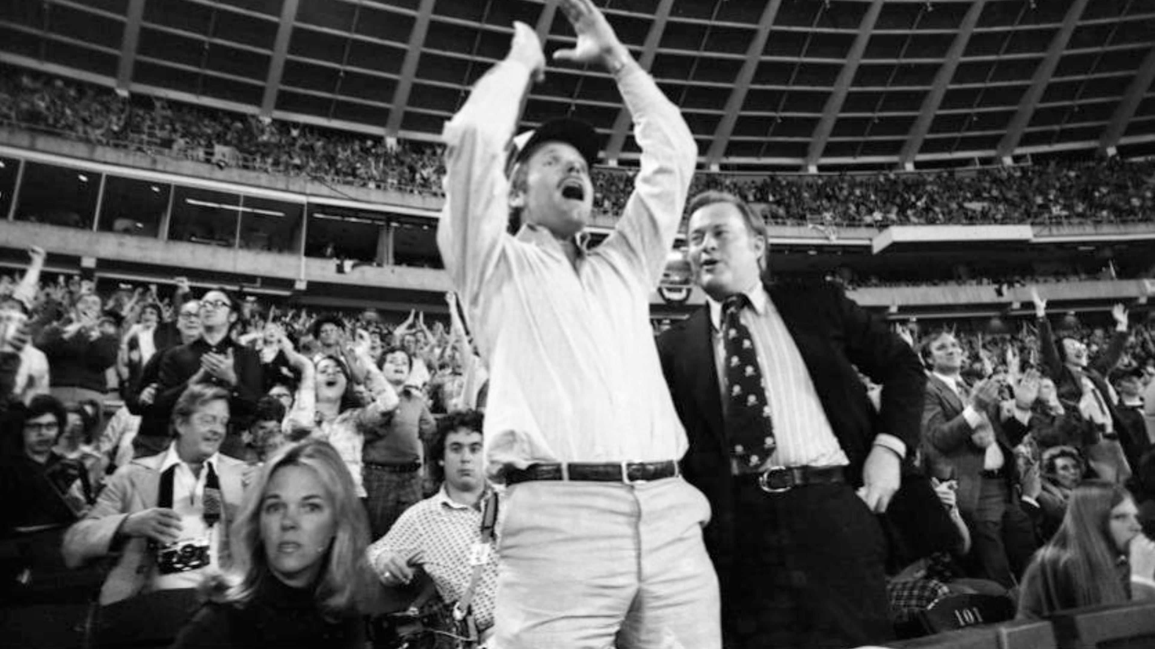 Ted Turner (center) celebrates as he watches the Braves play their home opener April 13, 1976. In Turner's first home game as the club's owner, the Braves lost 6-1 to the Reds. (Bud Skinner AJC 1976)