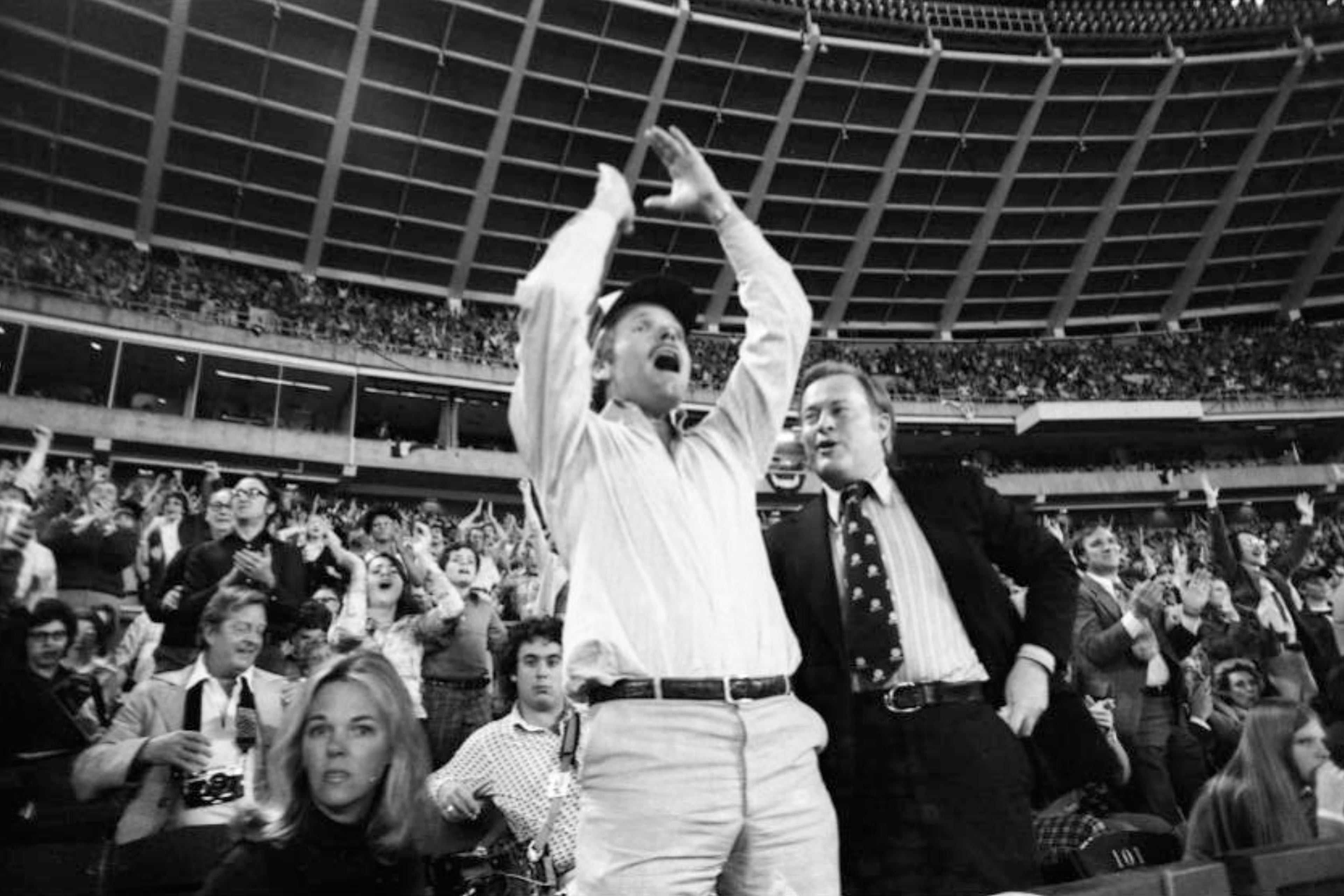Ted Turner (center) celebrates as he watches the Braves play their home opener April 13, 1976. In Turner's first home game as the club's owner, the Braves lost 6-1 to the Reds. (Bud Skinner AJC 1976)