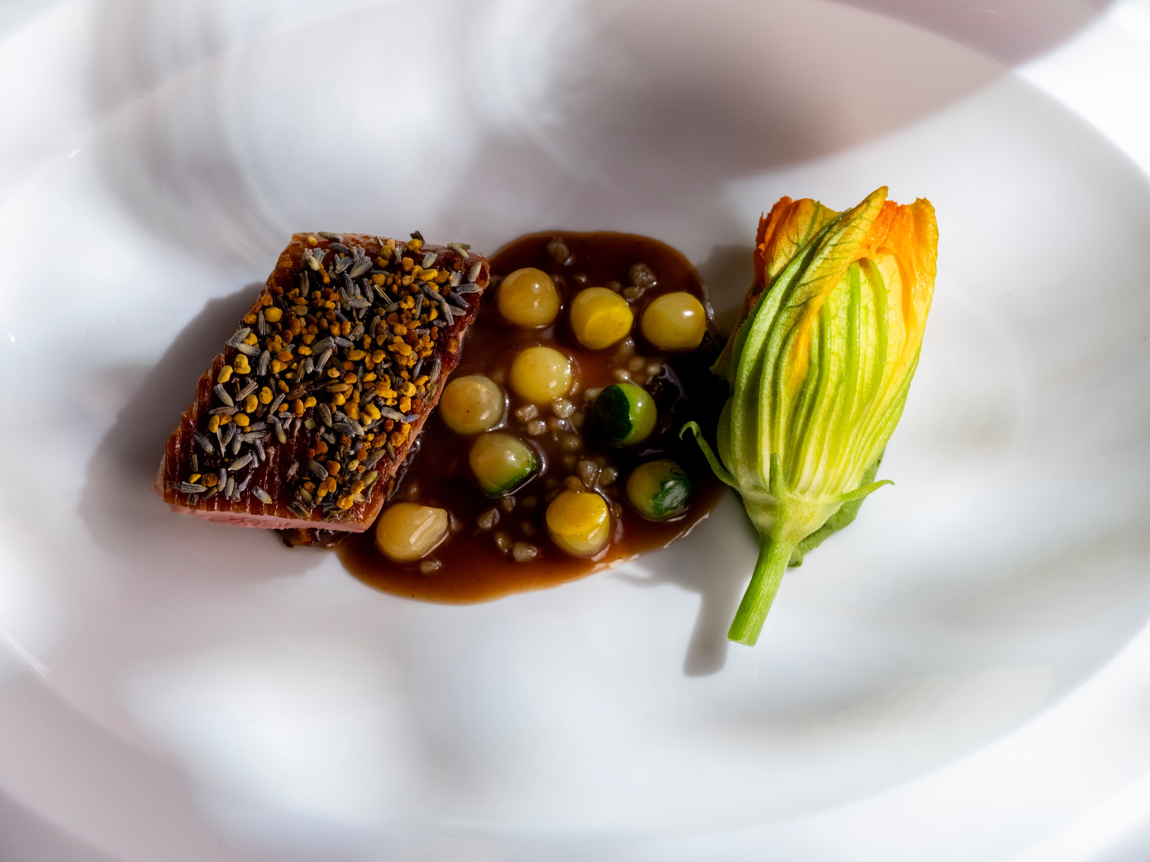 Stuffed squash blossoms are as much the star as the Hudson Valley duck on this delish dish at Midtown's Lazy Betty. (Courtesy of Matt Wong)