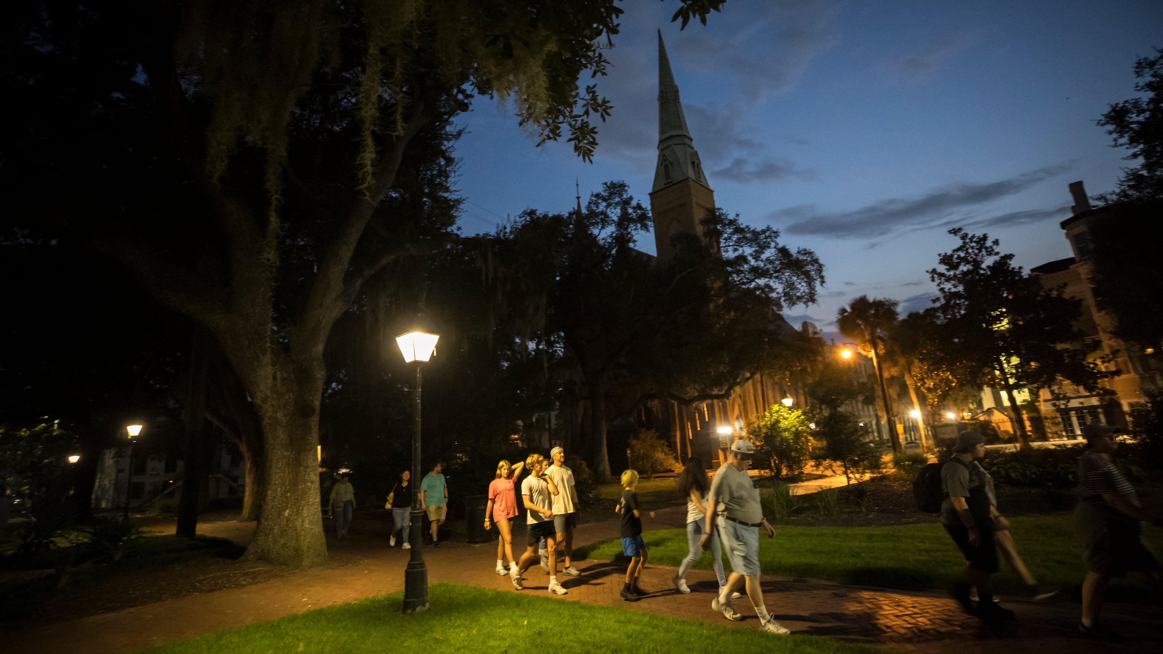 A ghost tour walks through Taylor Square (formerly known as Calhoun Square) in the heart of the landmark historic district. Tours through Taylor and other nearby squares are prohibited under a new 90-day pilot program. (AJC Photo/Stephen B. Morton)