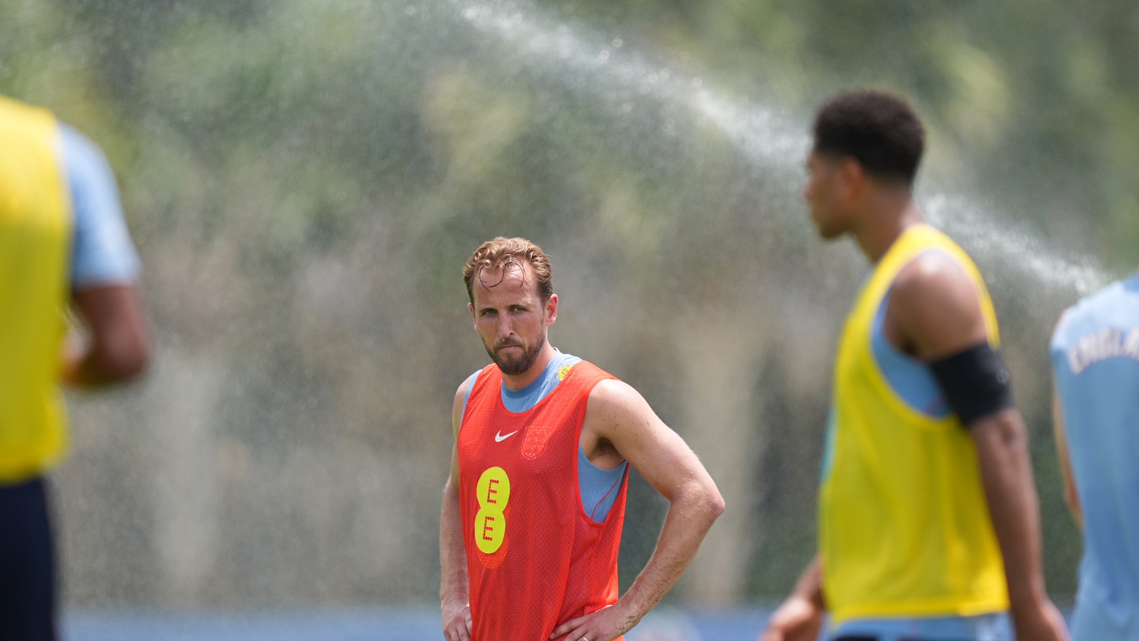 England forward Harry Kane stands near sprinklers during a training session for the national soccer team in Palm Beach Gardens, Fla., Tuesday, June 2, 2026, ahead of the World Cup soccer tournament. (AP Photo/Rebecca Blackwell)