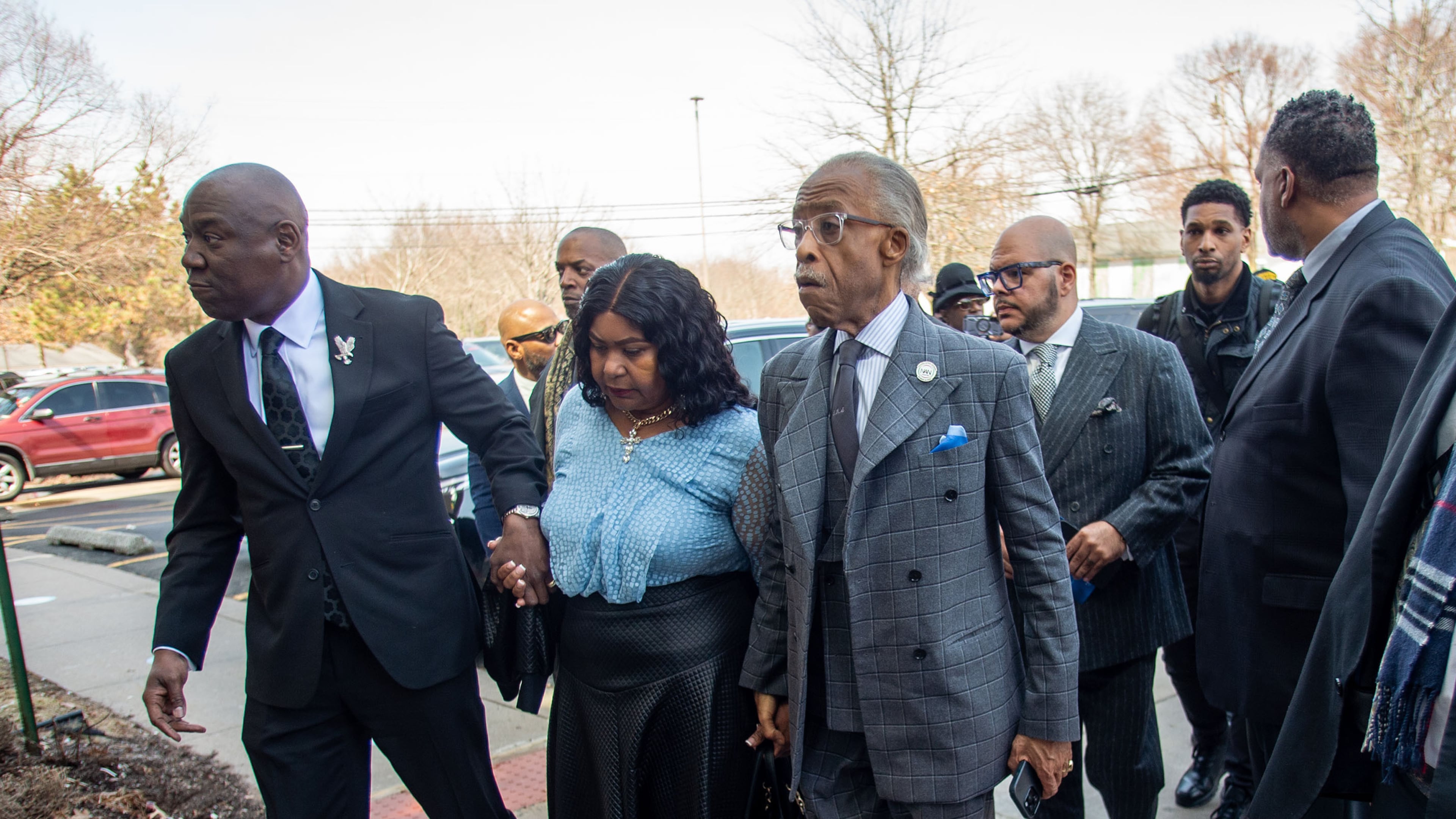 Attorney Ben Crump, left, and the Rev. Al Sharpton escort Audrey Jones, sister of Steven Jones, a man in a mental health crisis who was shot by police, into The First Cathedral for Jones's funeral service, Thursday, March 26, 2026 in Bloomfield, Conn. (Aaron Flaum/Hartford Courant via AP)