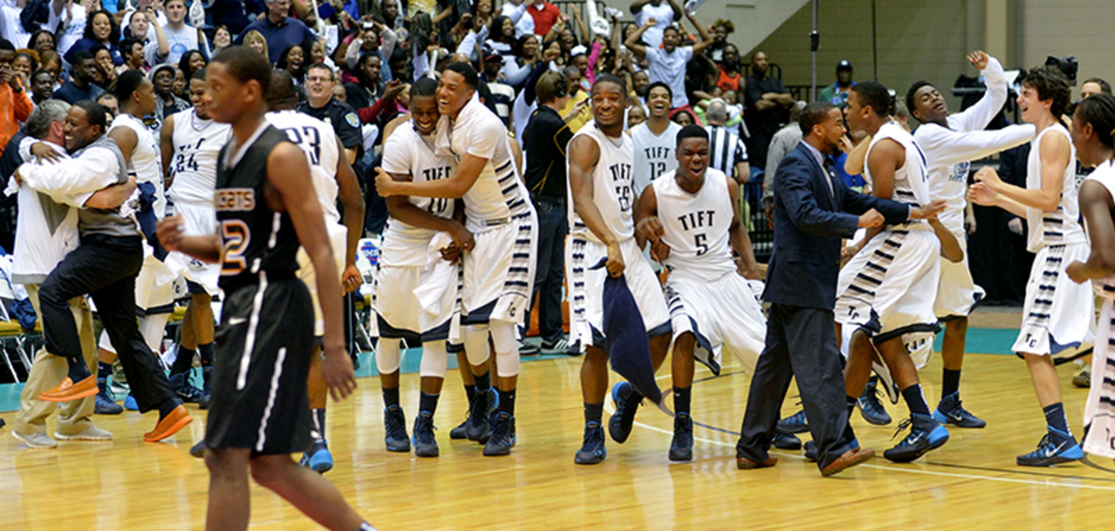 Tift County Blue Devils players celebrate winning the Class AAAAAA boys basketball championship over the Wheeler Wildcats, 63-49, Saturday, March 8, 2014, at the Macon Coliseum.