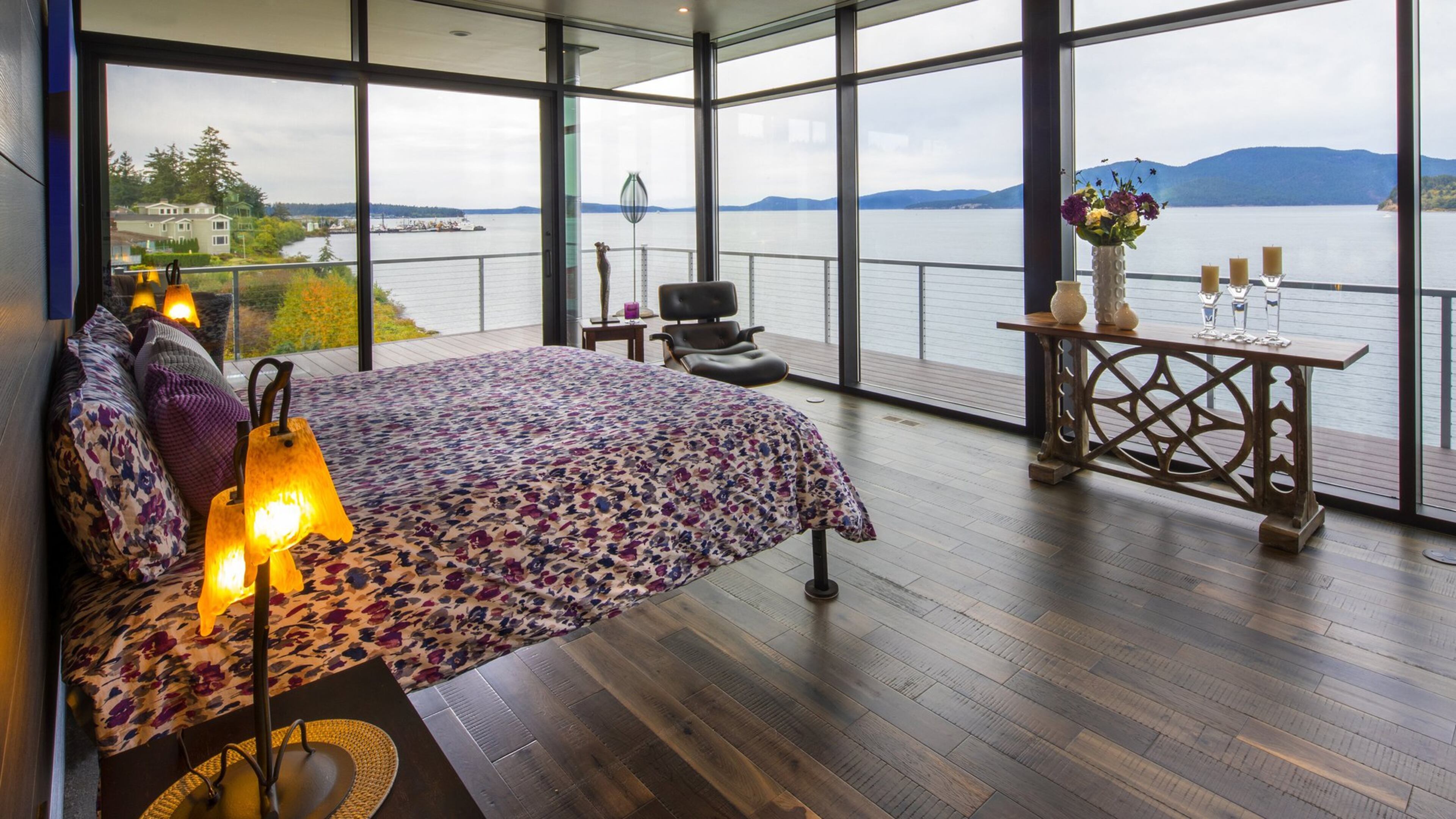 This is my favorite room, homeowner Frank Martin says of the all-glass-all-the-time upper-level master bedroom. I like the purple, says his wife, Kristi. And Brooks designed us a private deck out here. (Mike Siegel/The Seattle Times/TNS)