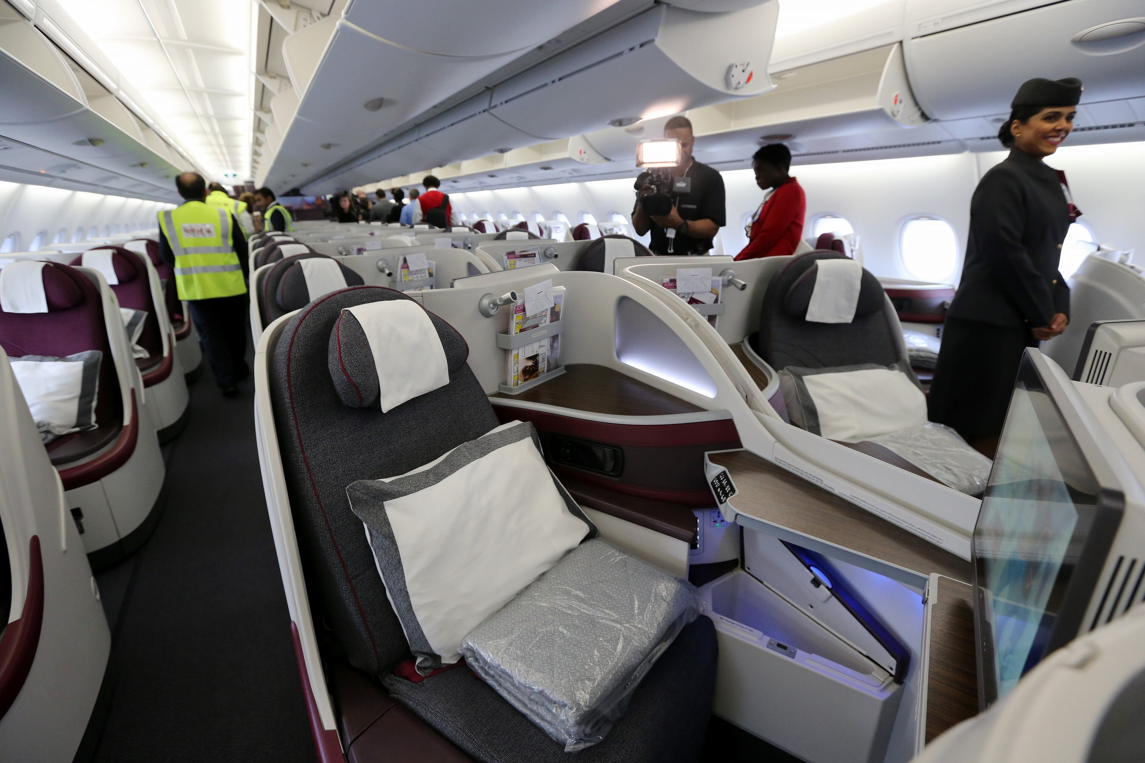 Photographers check out the business-class cabin in Qatar Airways A380 Wednesday evening June 1, 2016 during a press event to mark the inaugural flight to Doha. The airline brought the plane in for the first flight, but will be flying the route with a 777. Ben Gray / bgray@ajc.com