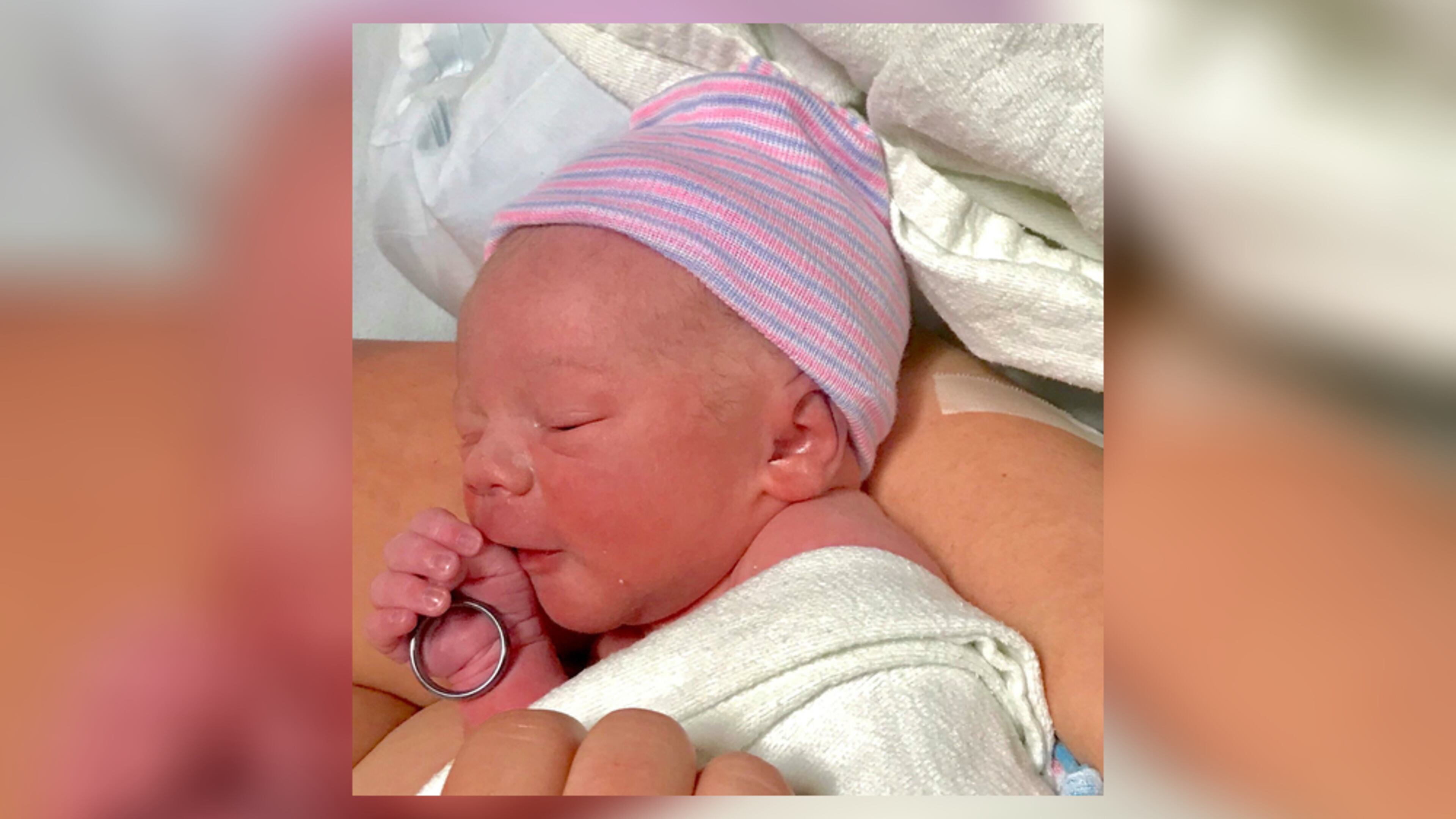 Bodie Allen Maddox, newborn son of slain officer Chase Maddox, holds his father's wedding ring. (Locust Grove Police Department)
