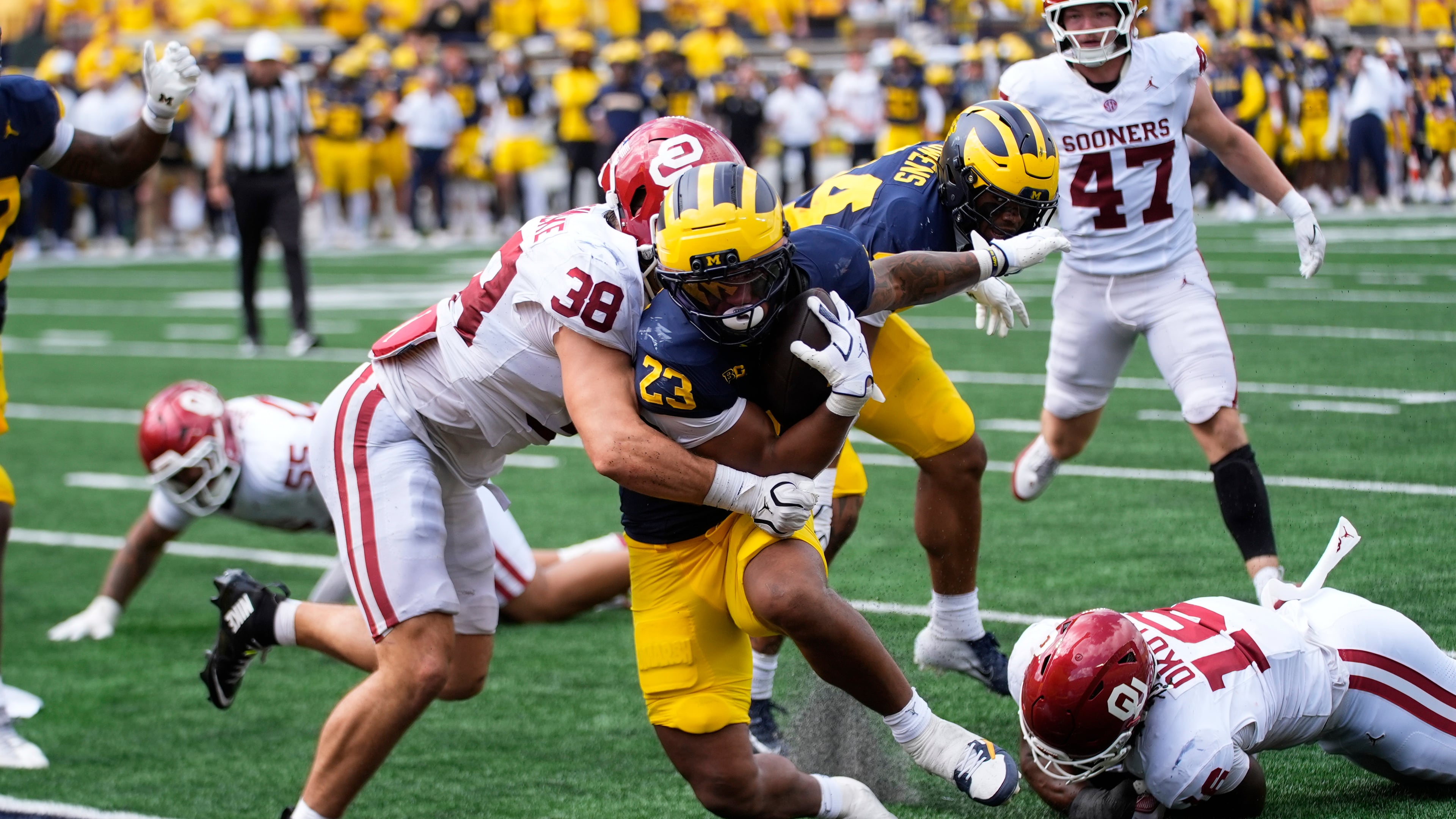 Michigan running back Jordan Marshall (23) scores a one-yard touchdown as Oklahoma linebacker Owen Heinecke (38) defends in the second half of an NCAA college football game Saturday, Sept. 12, 2026, in Ann Arbor, Mich. (AP Photo/Paul Sancya)