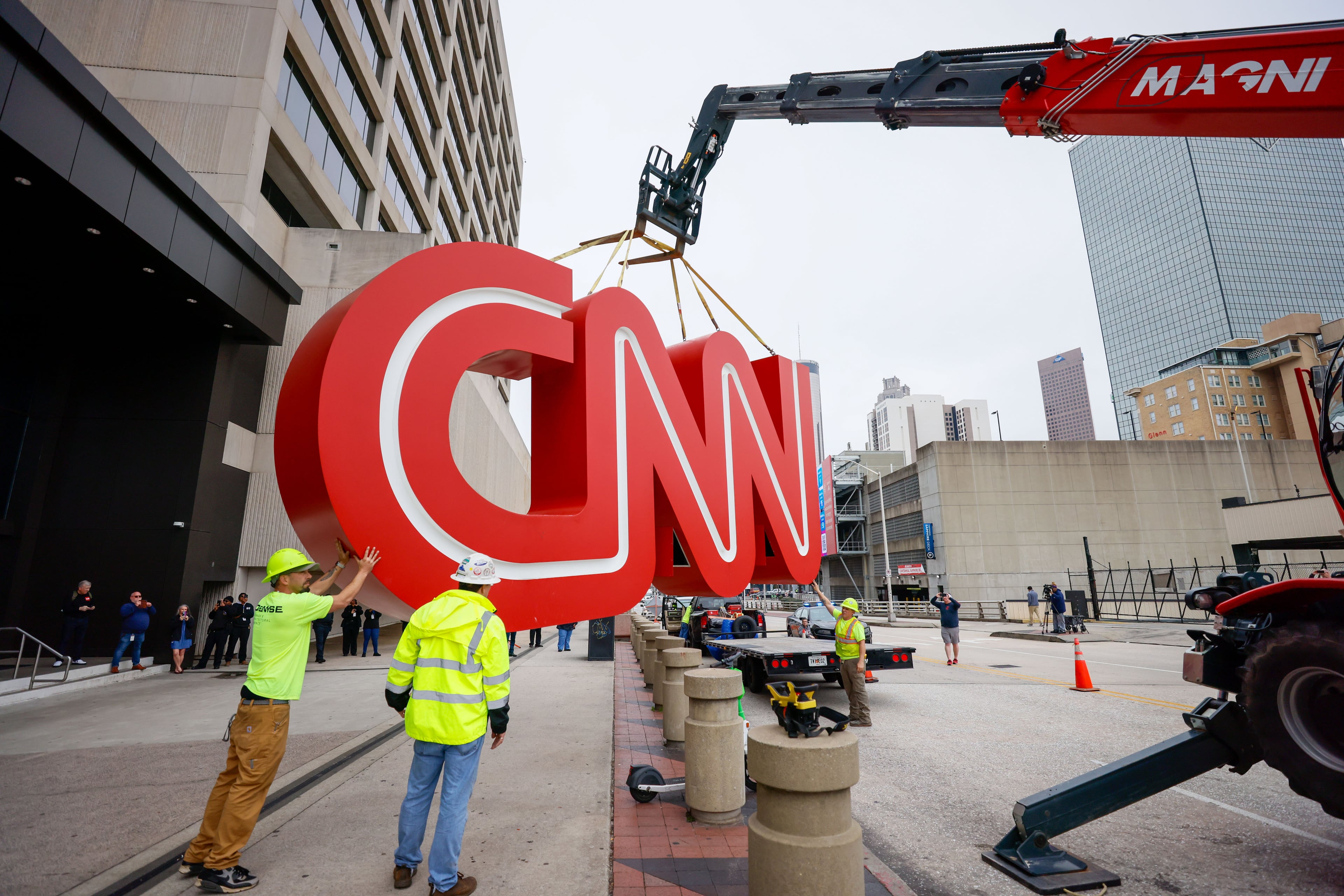After hours of work, a crane lifted the iconic CNN sign onto a flatbed truck on Monday, March 2024. The famous symbol will be renovated and relocated to the Techwood campus near the Warner Brothers studios in Midtown. Miguel Martinez miguel.martinezjimenez@ajc.com