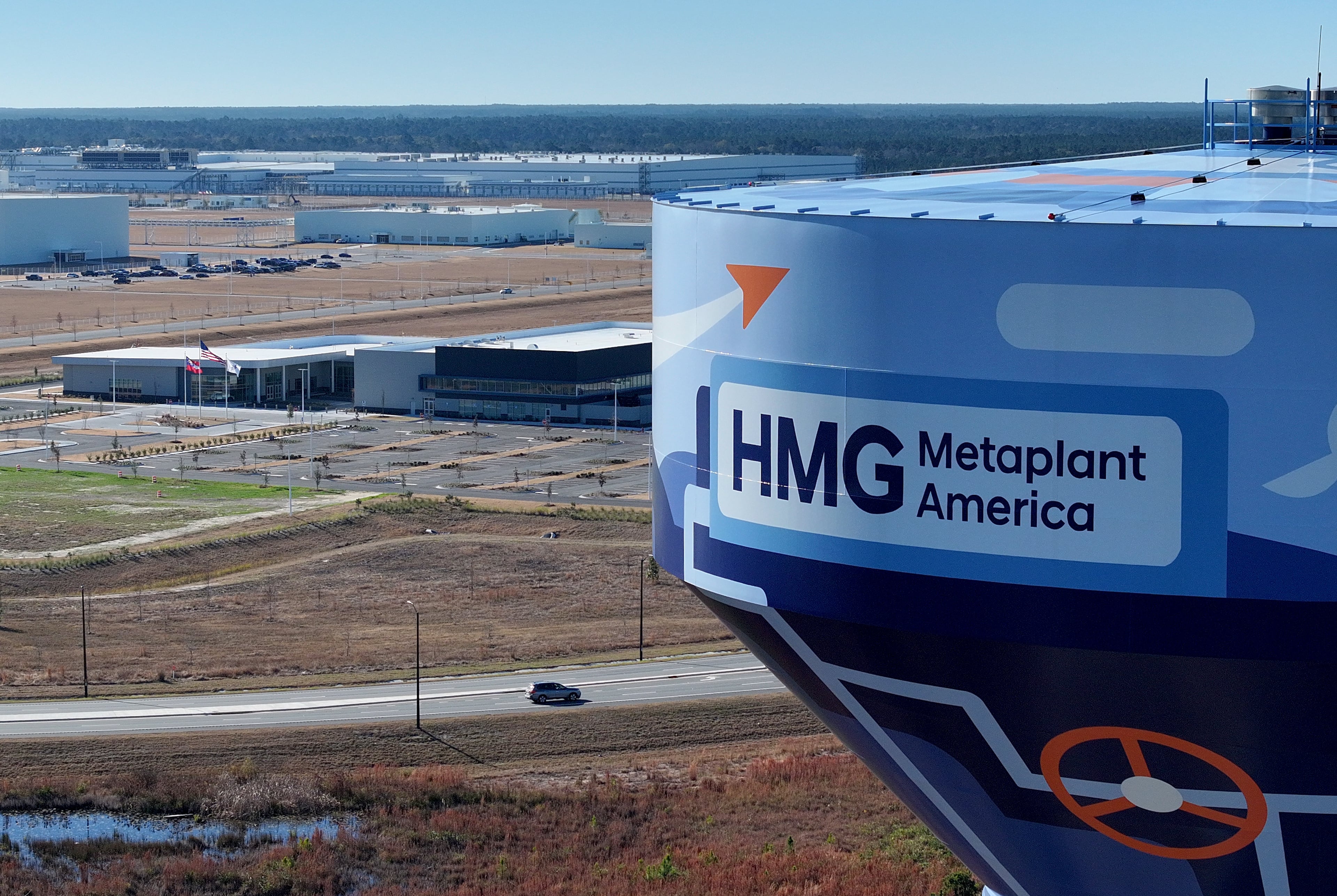 A car travels past Hyundai Motor Group Metaplant America (HMGMA) in Ellabell. (Hyosub Shin/AJC 2025)