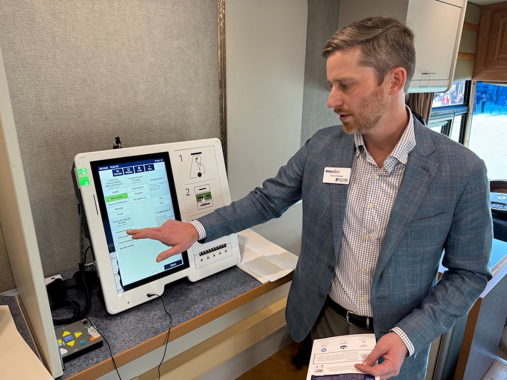 Chris Andrews, vice president of sales for Printelect, shows off a touchscreen voting system at the Georgia Capitol in March. (Adam Beam/AJC)