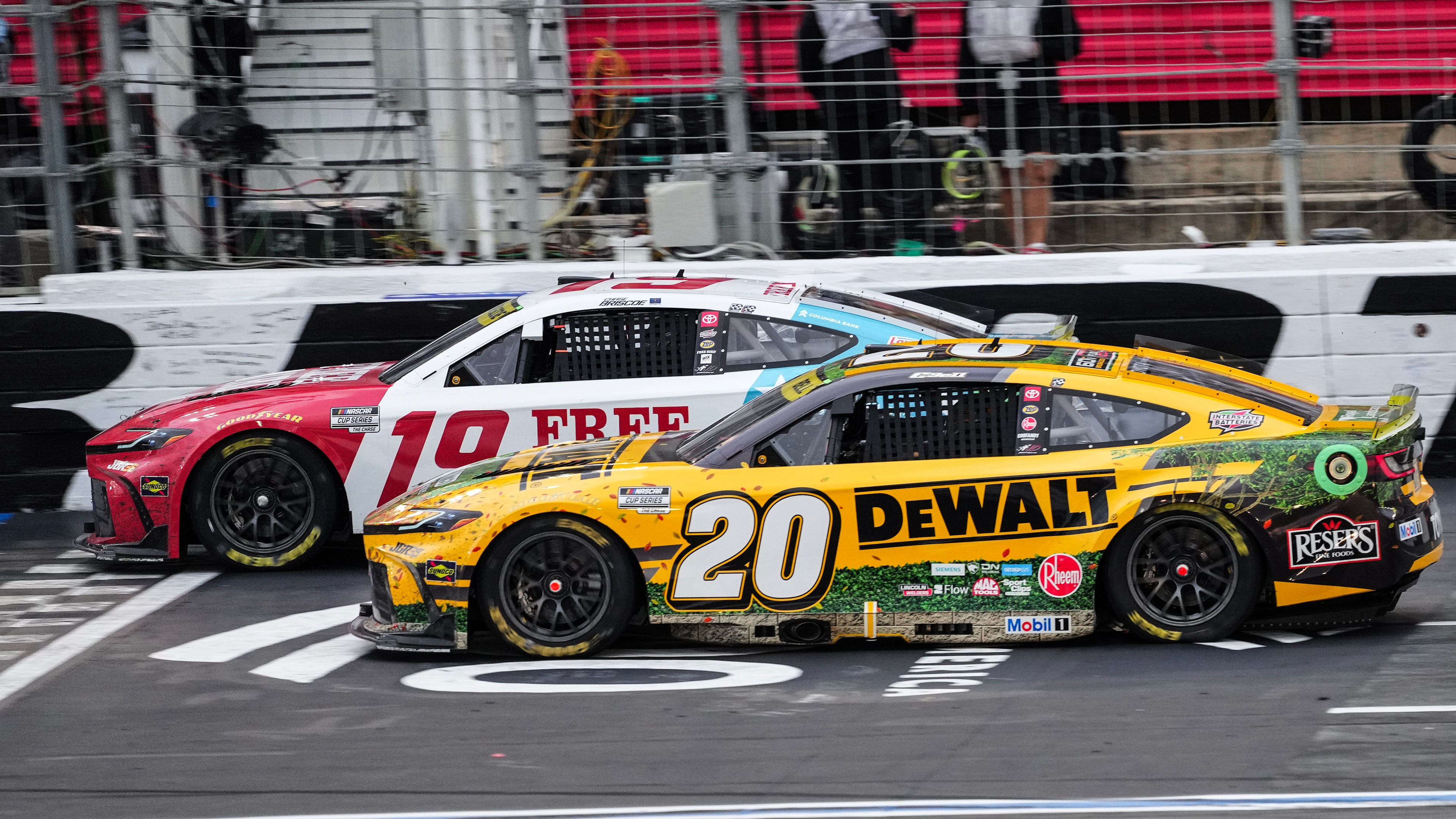 Chase Briscoe (19) beats Christopher Bell (20) to the finish line to win a NASCAR Cup Series auto race, Sunday, Oct. 11, 2026, in Concord, N.C. (AP Photo/Matt Kelley)