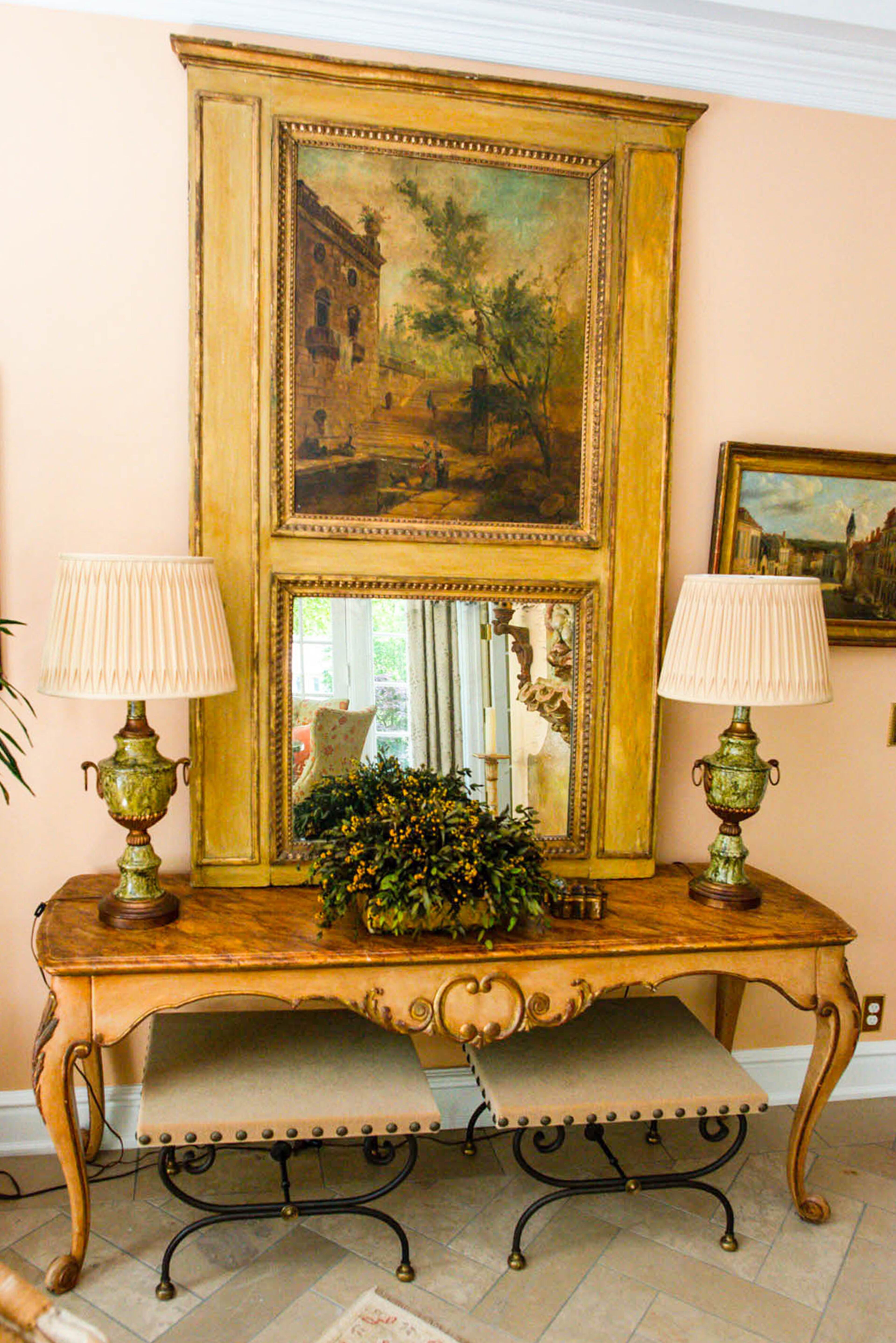 A Louis XVI French trumeau shows the homeowners' appreciation for European antiques in their neoclassical home in Atlanta.