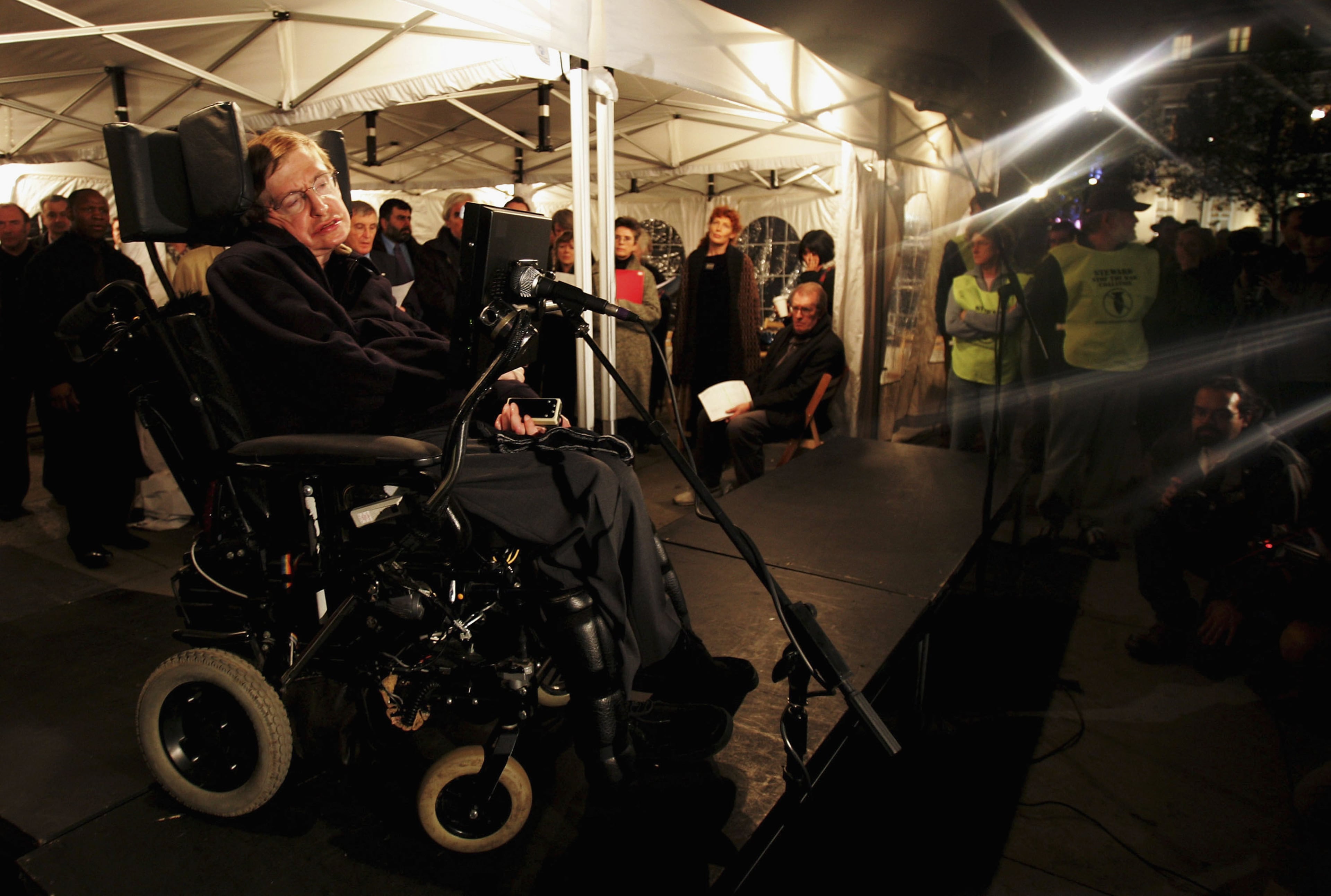 LONDON - NOVEMBER 2: Scientist Stephen Hawking reads out names during a vigil at Trafalgar Square at which a list of names of people killed in the Iraq war is read out November 2, 2004 in London. The vigil, organized by Stop the War Coalition is to coincide with similar events throughout the world on the day of the United States presidential election. (Photo by Ian Waldie/Getty Images)
