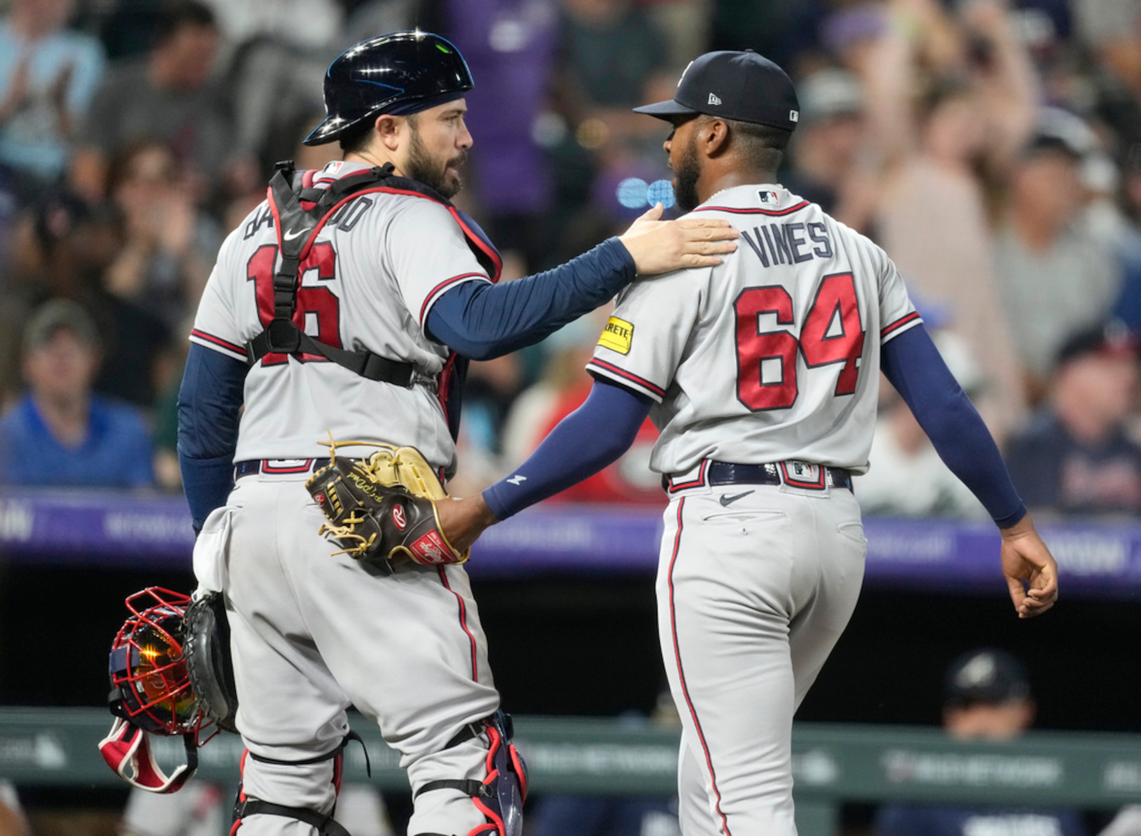 Braves catcher Travis d'Arnaud, left, congratulates rookie starting pitcher Darius Vines as they head to the dugout after the sixth inning against the Colorado Rockies Wednesday, Aug. 30, 2023, in Denver. Vines allowed just two earned runs in six innings in his first major-league game. The Braves won 7-3. (AP Photo/David Zalubowski)