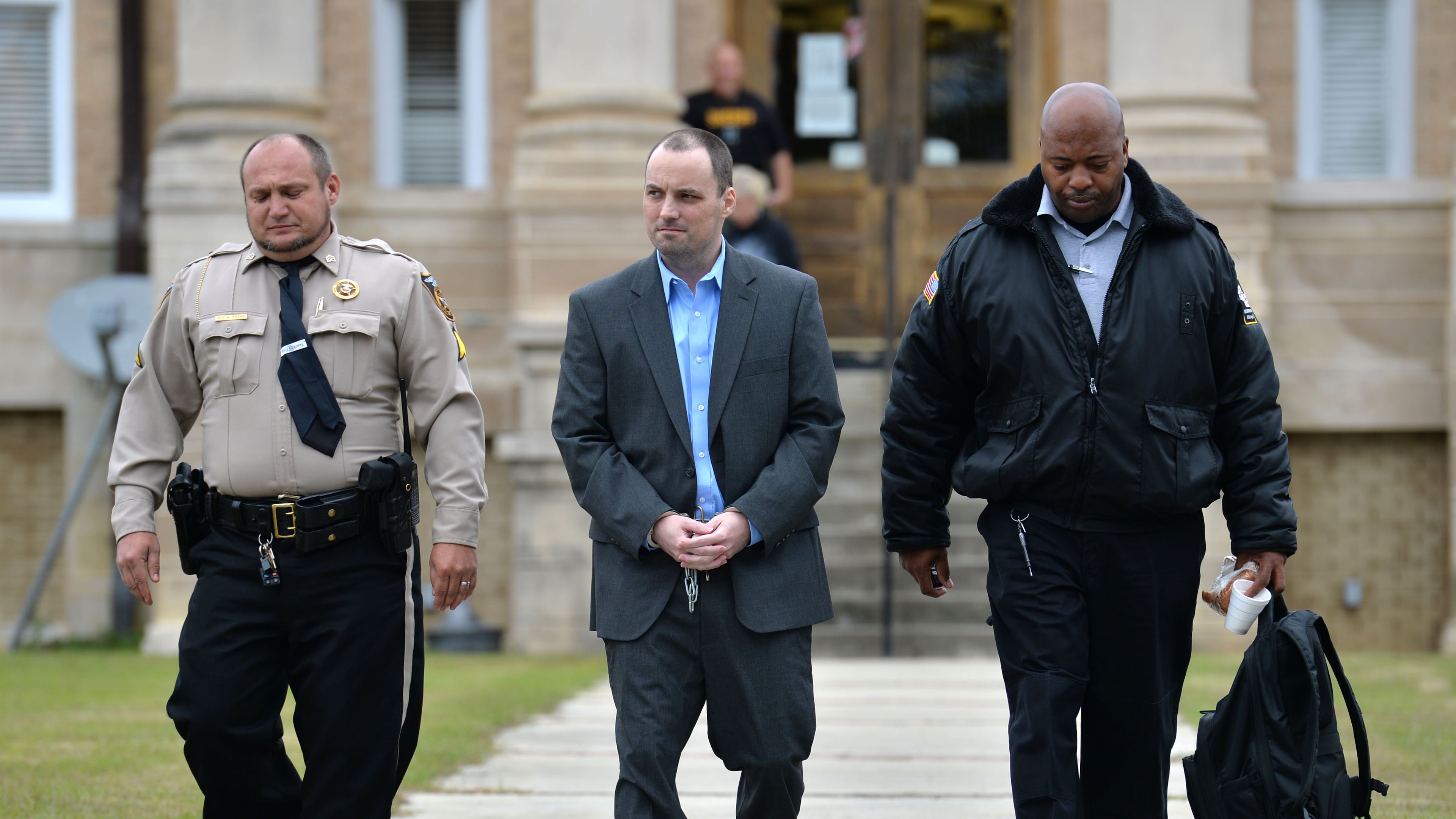 Ryan Alexander Duke, who is charged with murder in the Grinstead case, is escorted out after his motion hearings before Chief Judge of the Tifton Circuit Bill Reinhardt at Irwin County Courthouse in Ocilla on Monday.HYOSUB SHIN / AJC