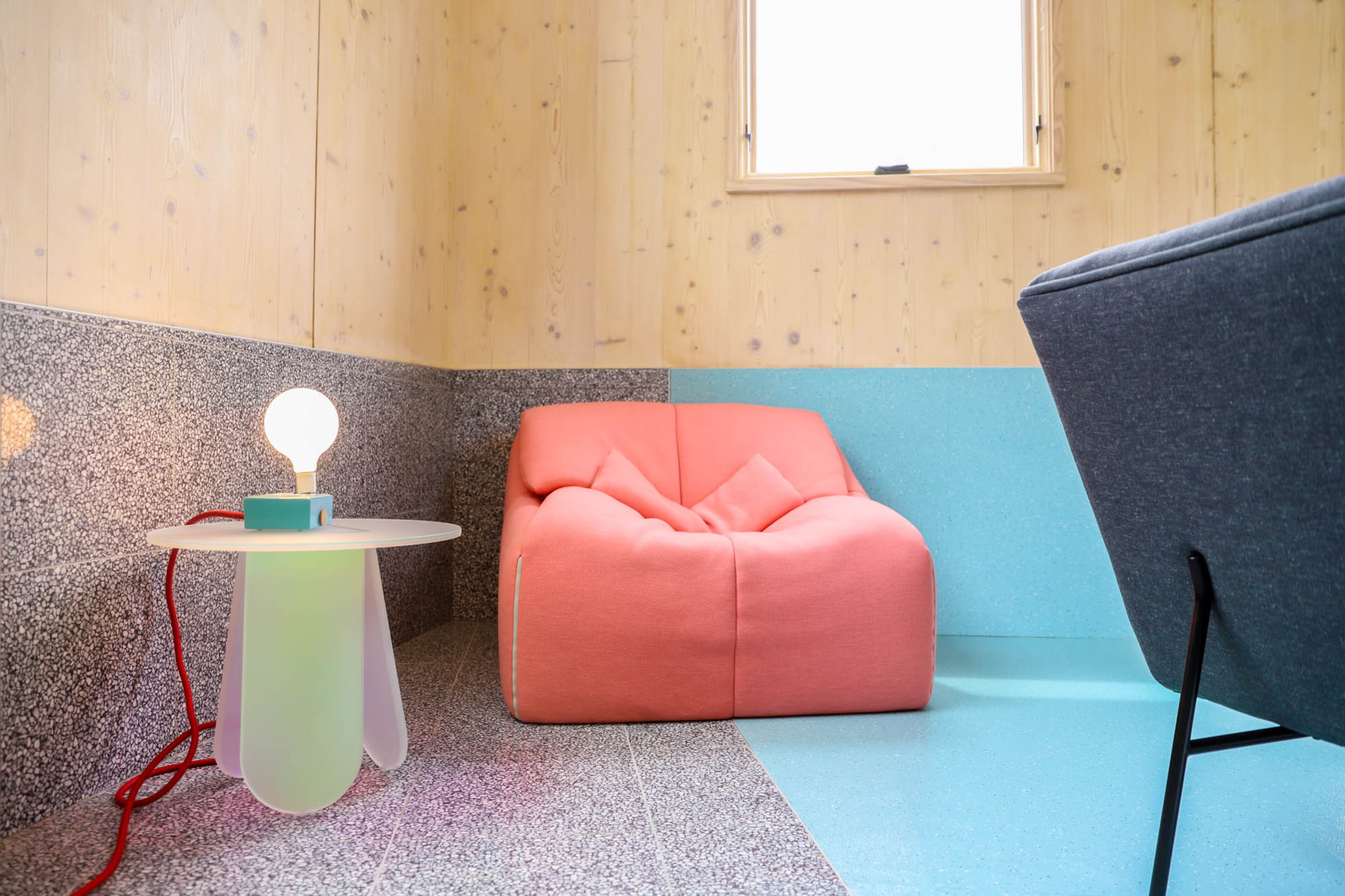 Ligne Roset's Plumy armchair is paired with Glas Italia's Shimmer table, purchased from Switch Modern. Homeowner Jennifer Bonner said both pieces are by amazing female furniture designers - Patricia Urquiola for the table and Annie Hieronimus for the chair - and perfect complements to the living space and color.