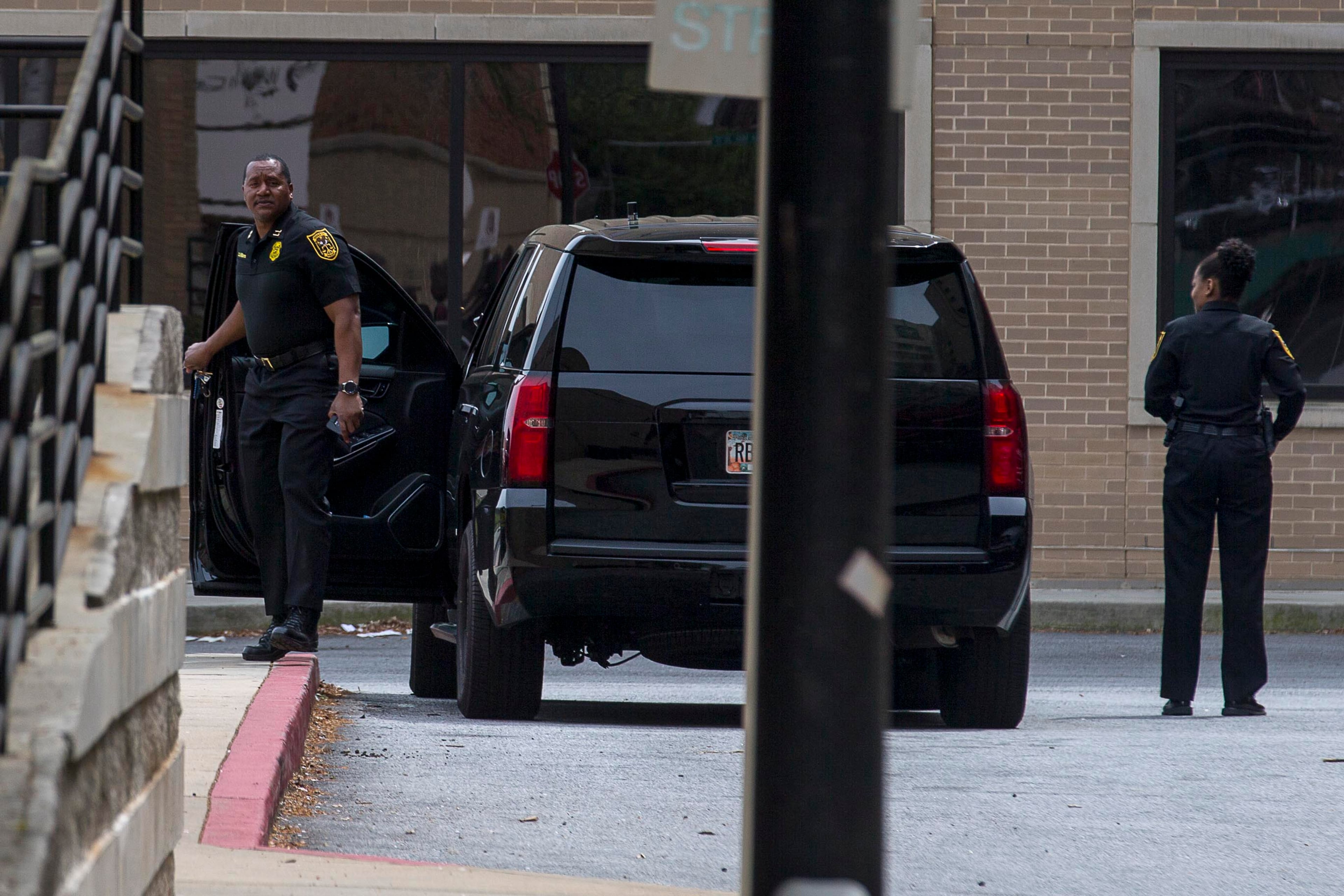 Two police officers prepare to enter the Marcus Trauma Center at Grady Memorial Hospital in Atlanta, Thursday, April 4, 2019. Two police officers were shot in Henry County and were brought to Grady hospital for treatment. (ALYSSA POINTER/ALYSSA.POINTER@AJC.COM)