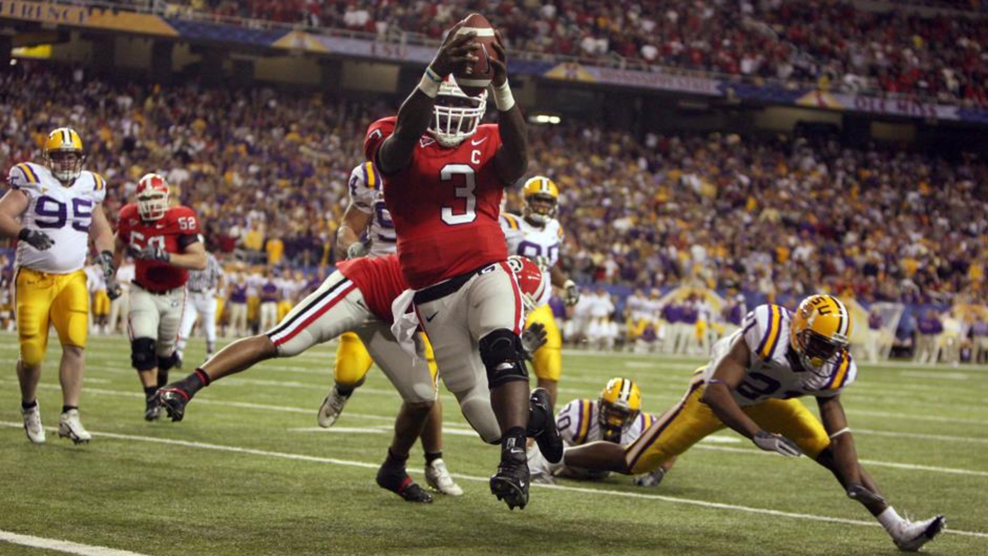 UGA quarterback D.J. Shockley (3) runs into the end zone for a score in 2005. Brant Sanderlin/AJC Staff