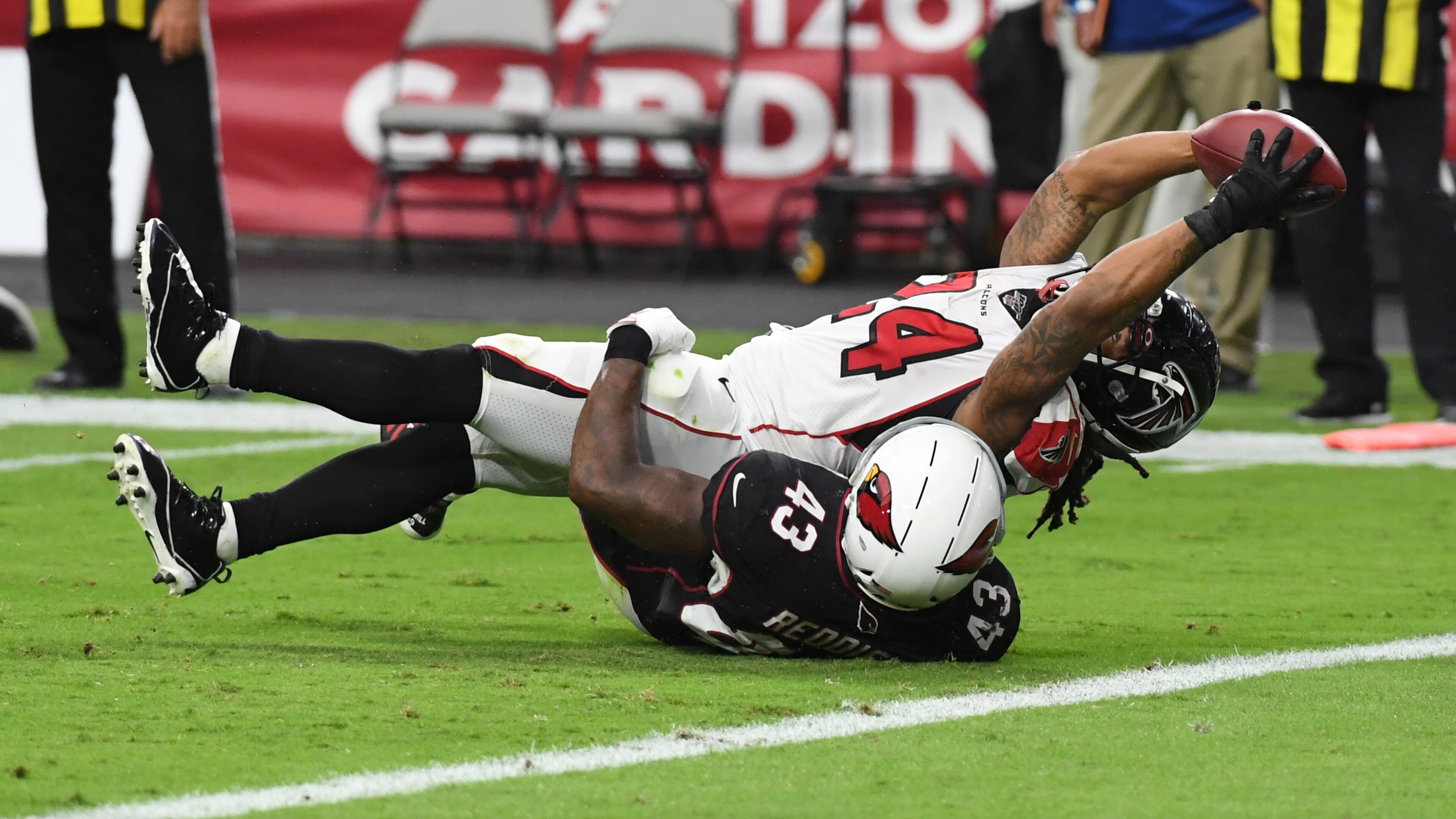 Falcons running back Devonta Freeman stretches the ball over the goal line for a touchdown while being tackled by Arizona's Haason Reddick during the second half Oct. 13, 2019, at State Farm Stadium in Glendale, Ariz.