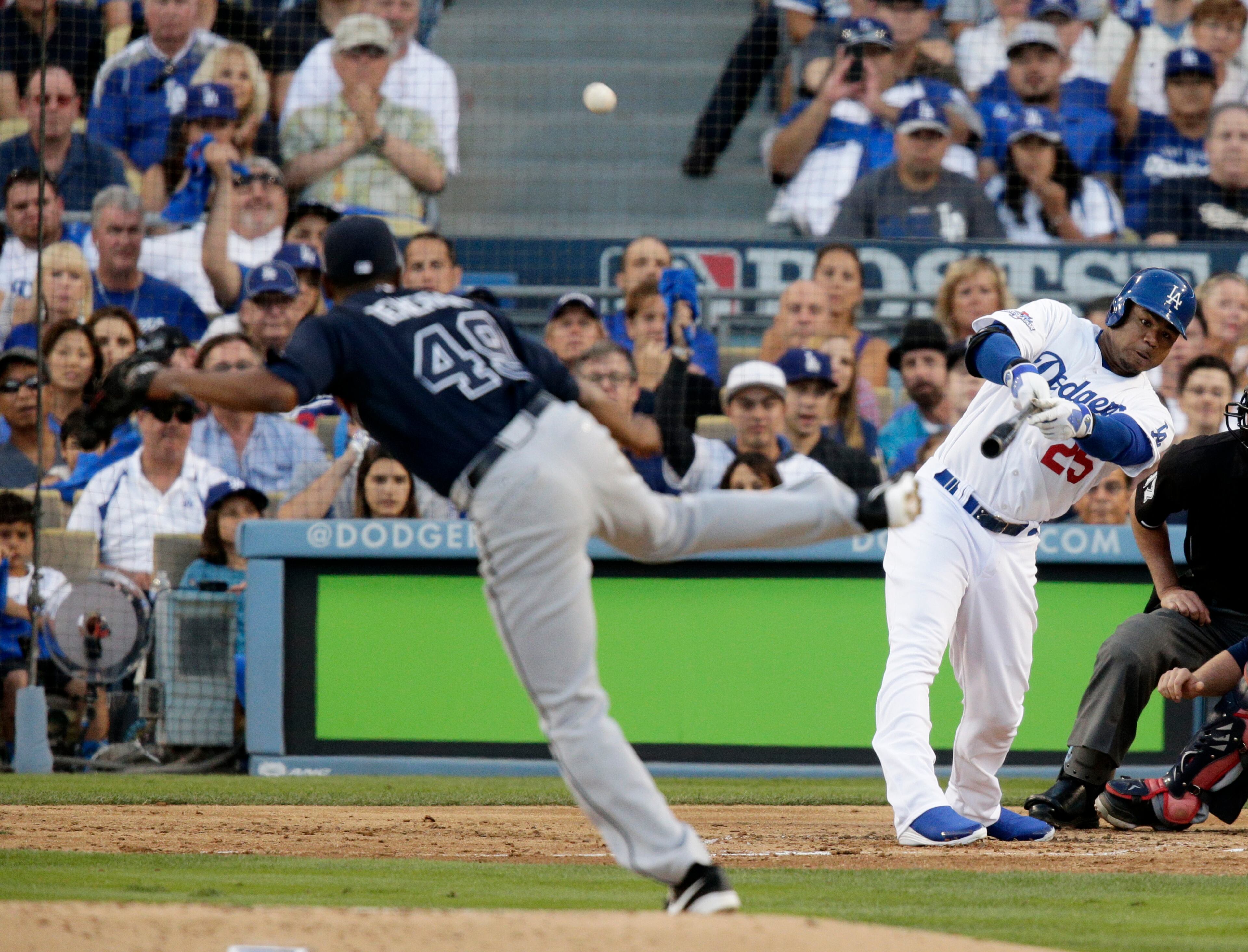 Los Angeles Dodgers' Carl Crawford, right, hits a three-run home run off of Atlanta Braves starting pitcher Julio Teheran, left, in the second inning of Game 3 of the National League division baseball series, Sunday, Oct. 6, 2013, in Los Angeles.