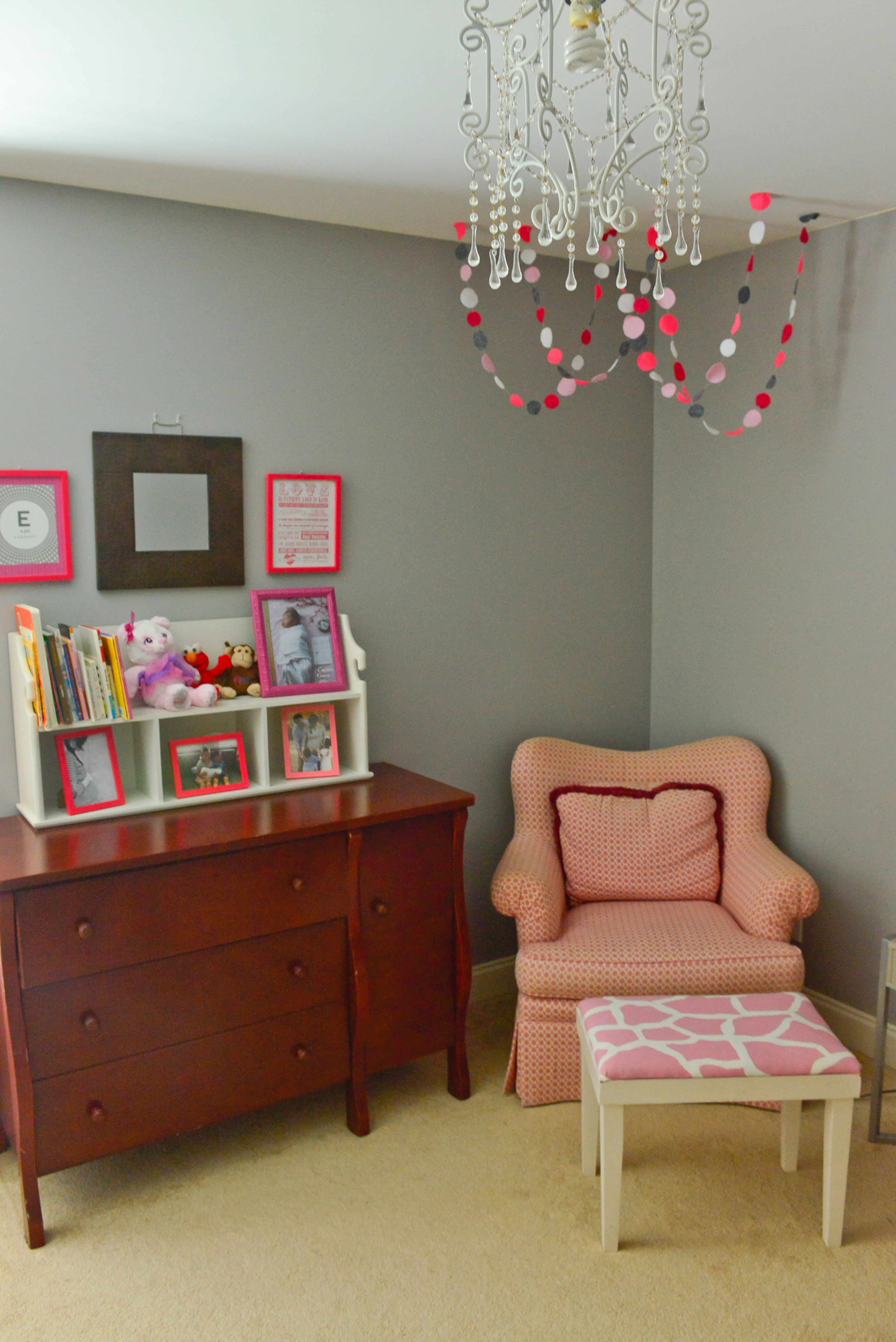 Homeowner Yuni Min likes to use neutral paint colors on her kids's bedroom walls, just in case they ever want to switch rooms. This pink armchair, a Goodwill find in great condition, and chandelier that was a gift from a friend, add feminine flair to 3-year-old Emmy's room. Christopher Oquendo/AJC FILE
