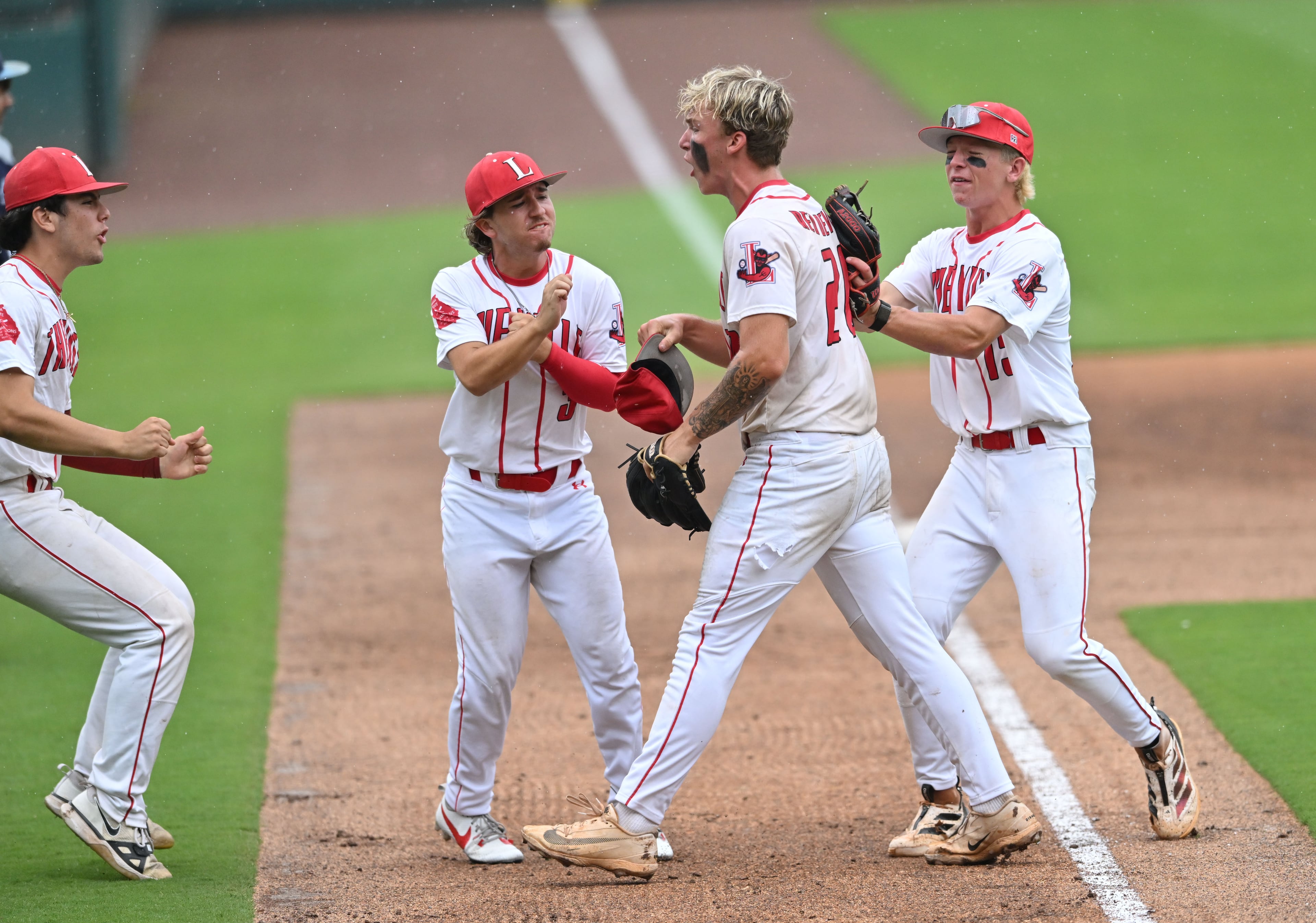 Loganville pitcher Jake Boland (second from right) celebrates with teammates after beating Pope during Game 1 of the GHSA Class 5A baseball state championship series Monday, May 25, 2026, at Gwinnett Field in Lawrenceville. Loganville won 3-2. (Hyosub Shin/AJC)