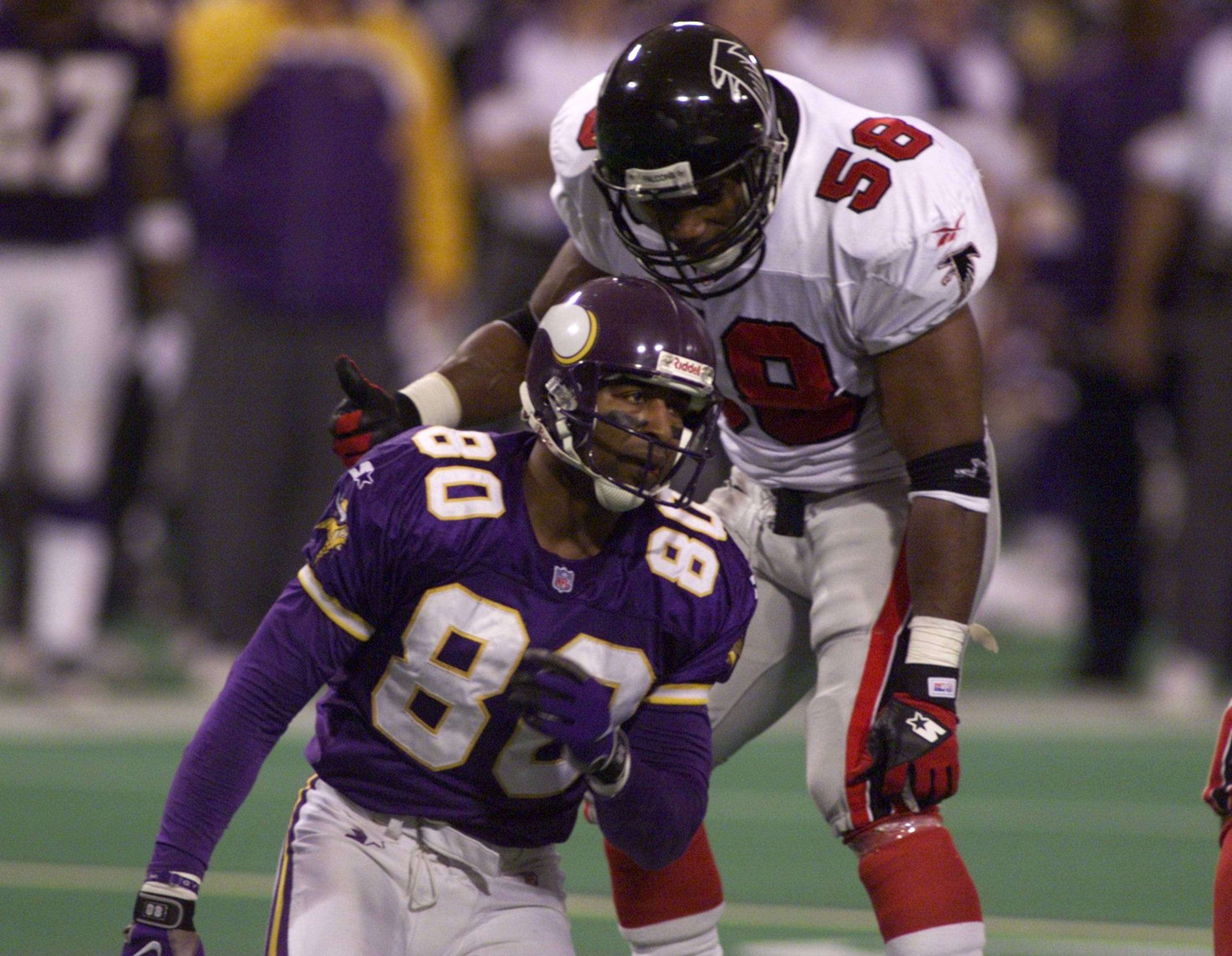 980117 Minneapolis, MN-Atlanta Falcons Jessie Tuggle has a few words for Minnnasota's Chris Carter after breaking up a pass intended for him. (AJC Staff Photo/Marlene Karas)