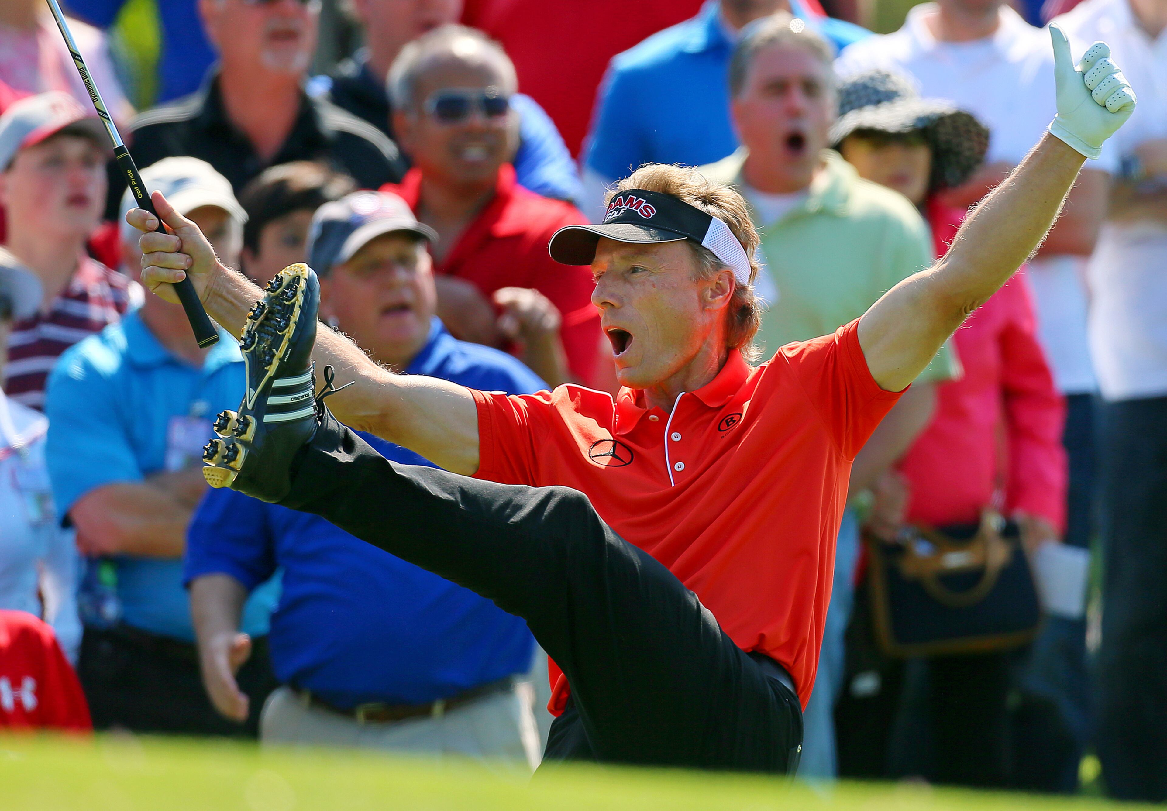 Bernhard Langer kicks his foot in the air as he chips in for a birdie from off the 10th green to go 8-under par for a two stroke lead in the Greater Gwinnett Championship at TPC Sugarloaf on Sunday, April 21, 2013, in Duluth. Langer won the tournament by three strokes finishing at 10-under par.