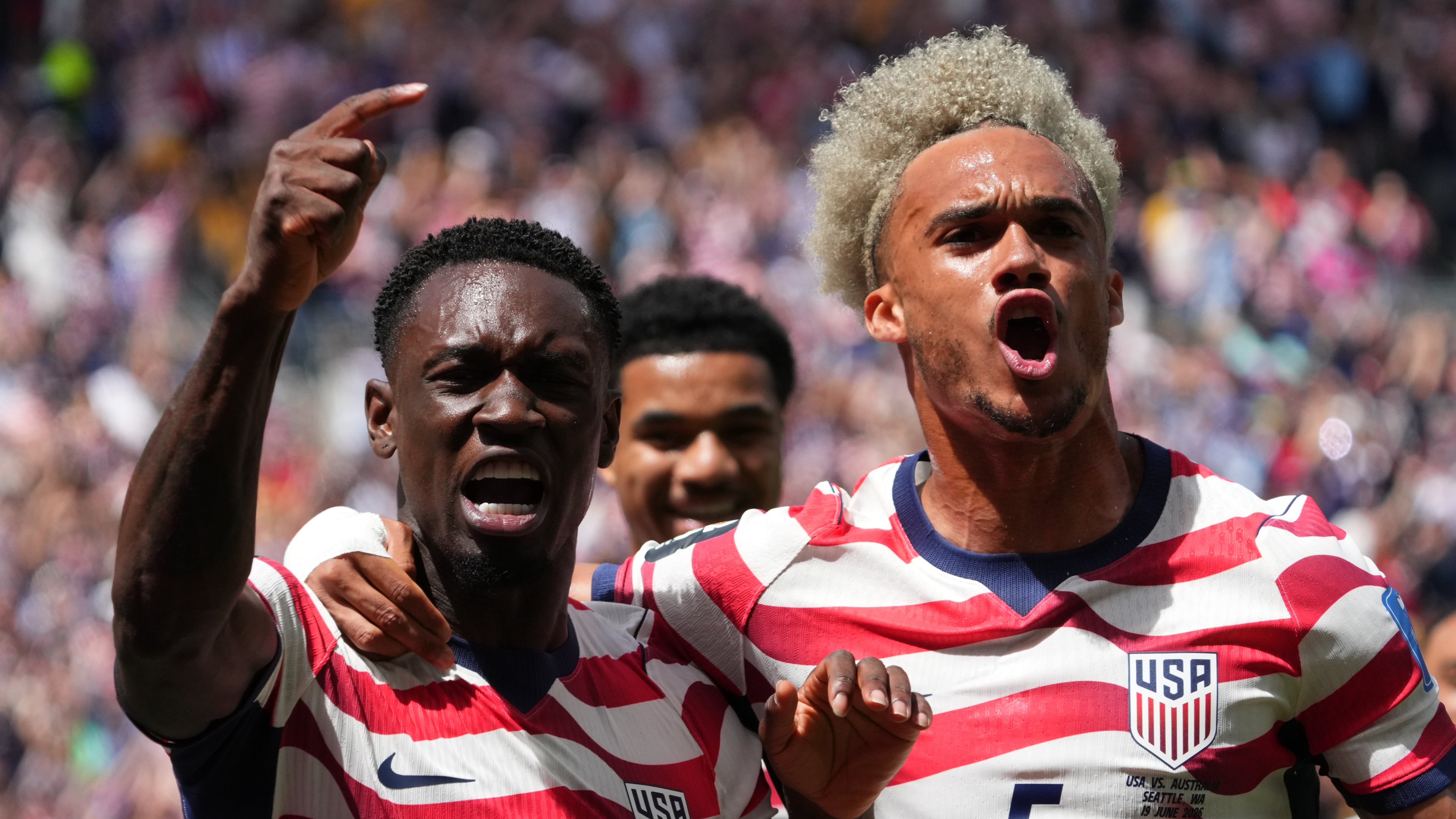 United States' Folarin Balogun (20) and Antonee Robinson (5) celebrate after scoring during the World Cup Group D soccer match between the United States and Australia in Seattle, Friday, June 19, 2026. (AP Photo/Ted S. Warren)