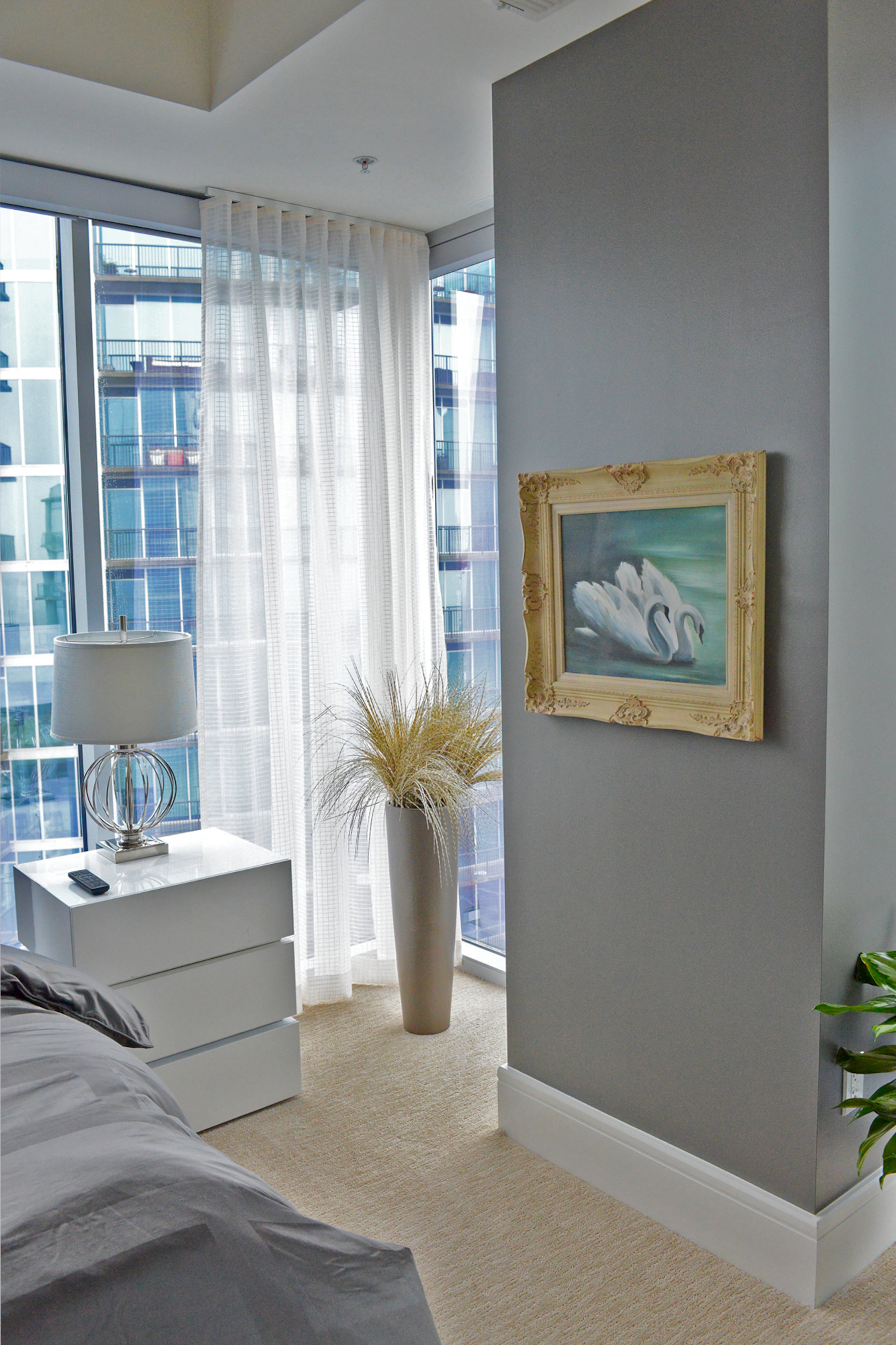 The swan painting in Jim Wilson's bedroom is the first piece of art that he and his late wife, Sydney, bought in 1982 in Florida. It's among the pieces he kept when he downsized from a home in Virginia-Highland and moved into a condo in 1065 Midtown.