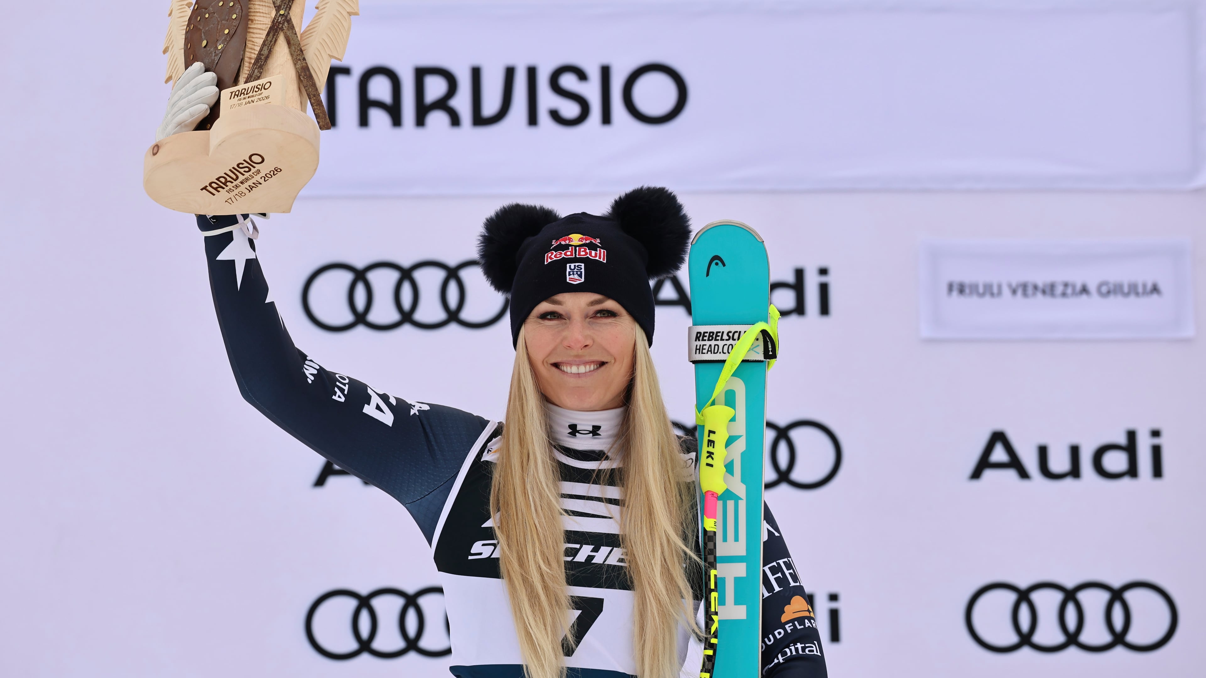 United States' Lindsey Vonn celebrates on the podium after taking second place in an alpine ski, women's World Cup Super G, in Tarvisio, Italy, Sunday, Jan. 18, 2026. (AP Photo/Marco Trovati)