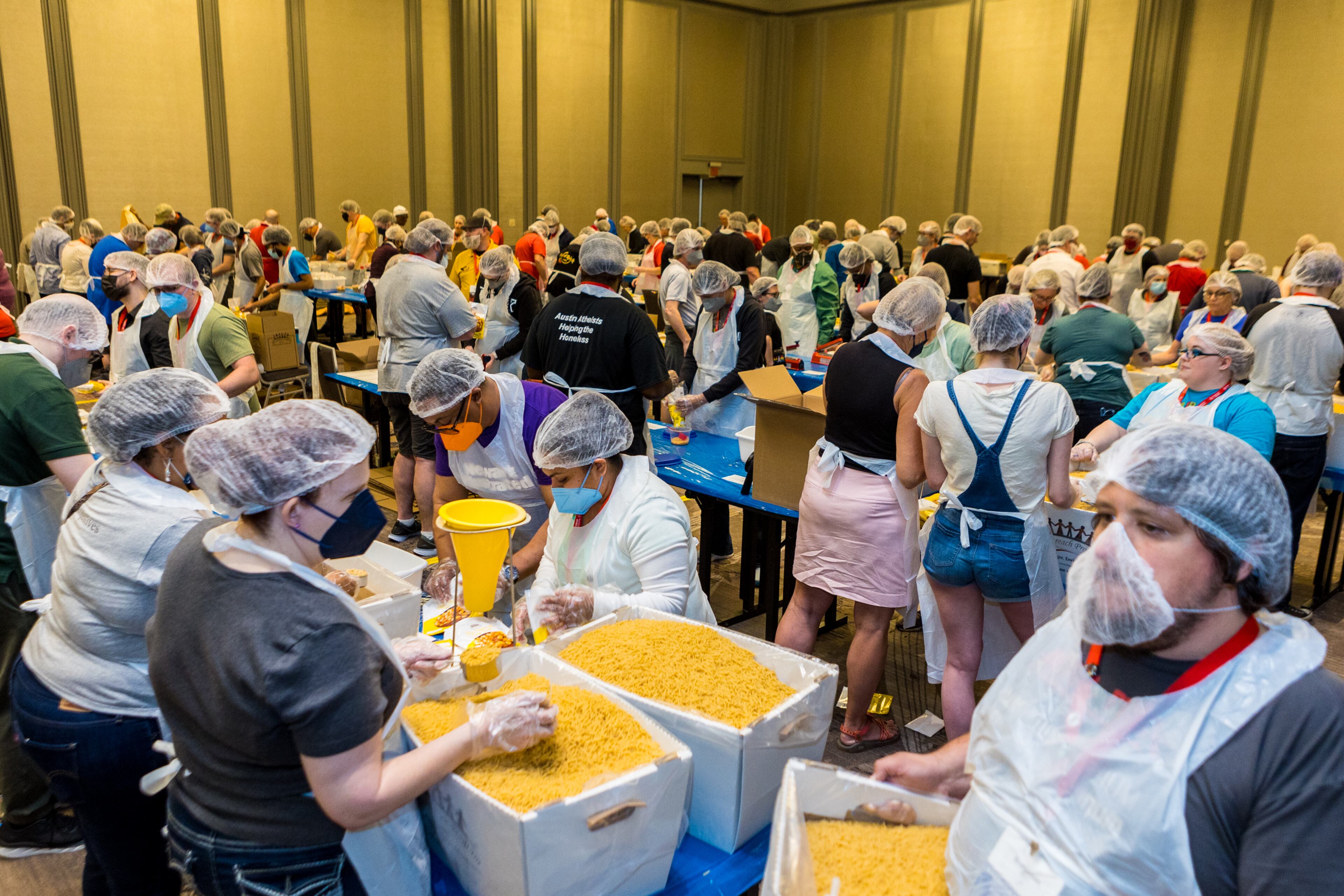 Volunteers give their time to package dinners for metro Atlanta charities on Sunday, April 17, 2022, after the formal closing of the American Atheists 2022 National Convention. Hundreds of atheists gathered in Atlanta on Easter weekend for the New Jersey-based nonprofit's first in-person convention since 2019. (Photo: Jenni Girtman for The Atlanta Journal-Constitution)