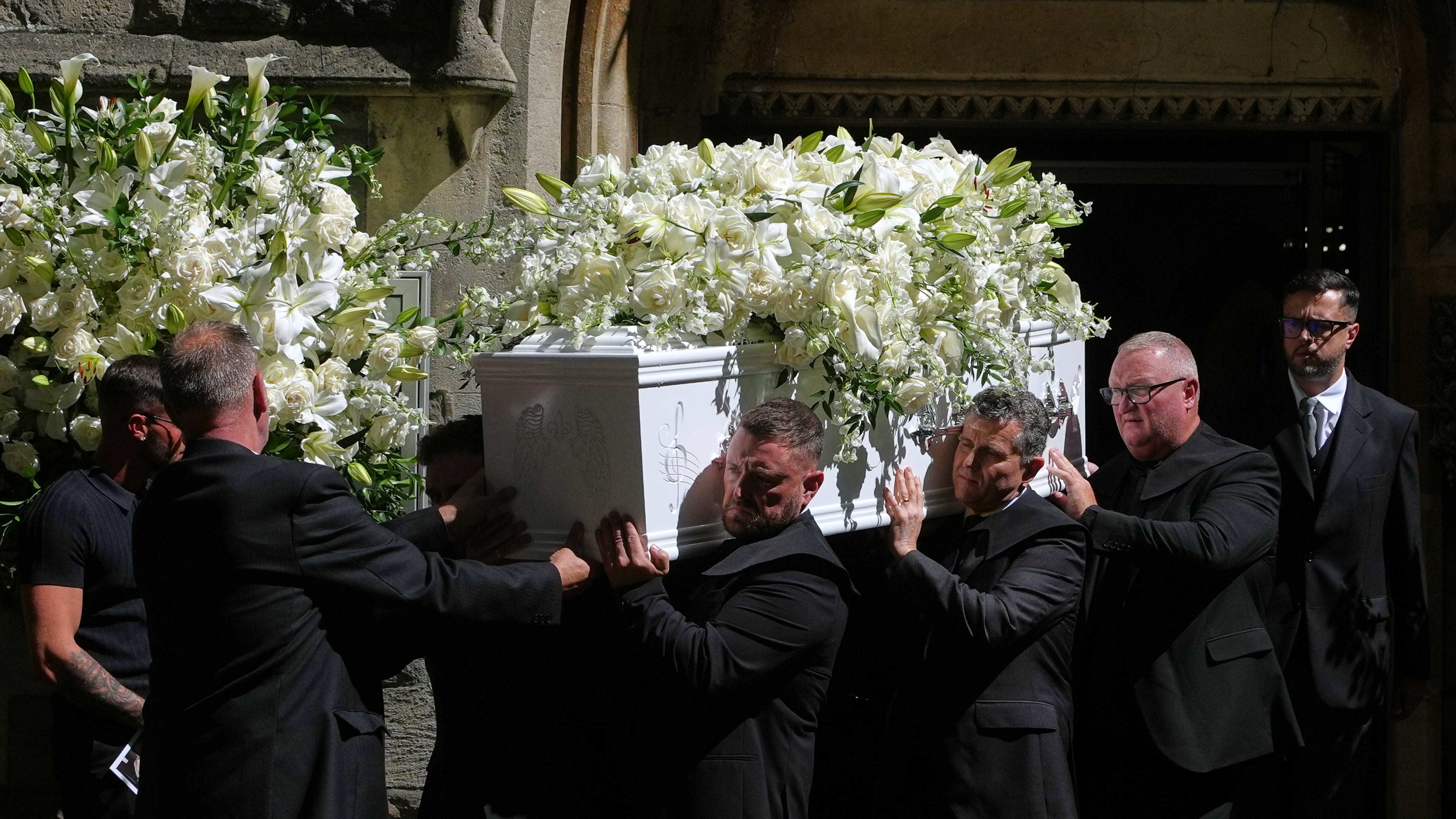 The coffin is taken from Swansea Minster following the funeral of Bonnie Tyler in Swansea, Wales, Monday, Aug. 17, 2026. (AP Photo/Alastair Grant)
