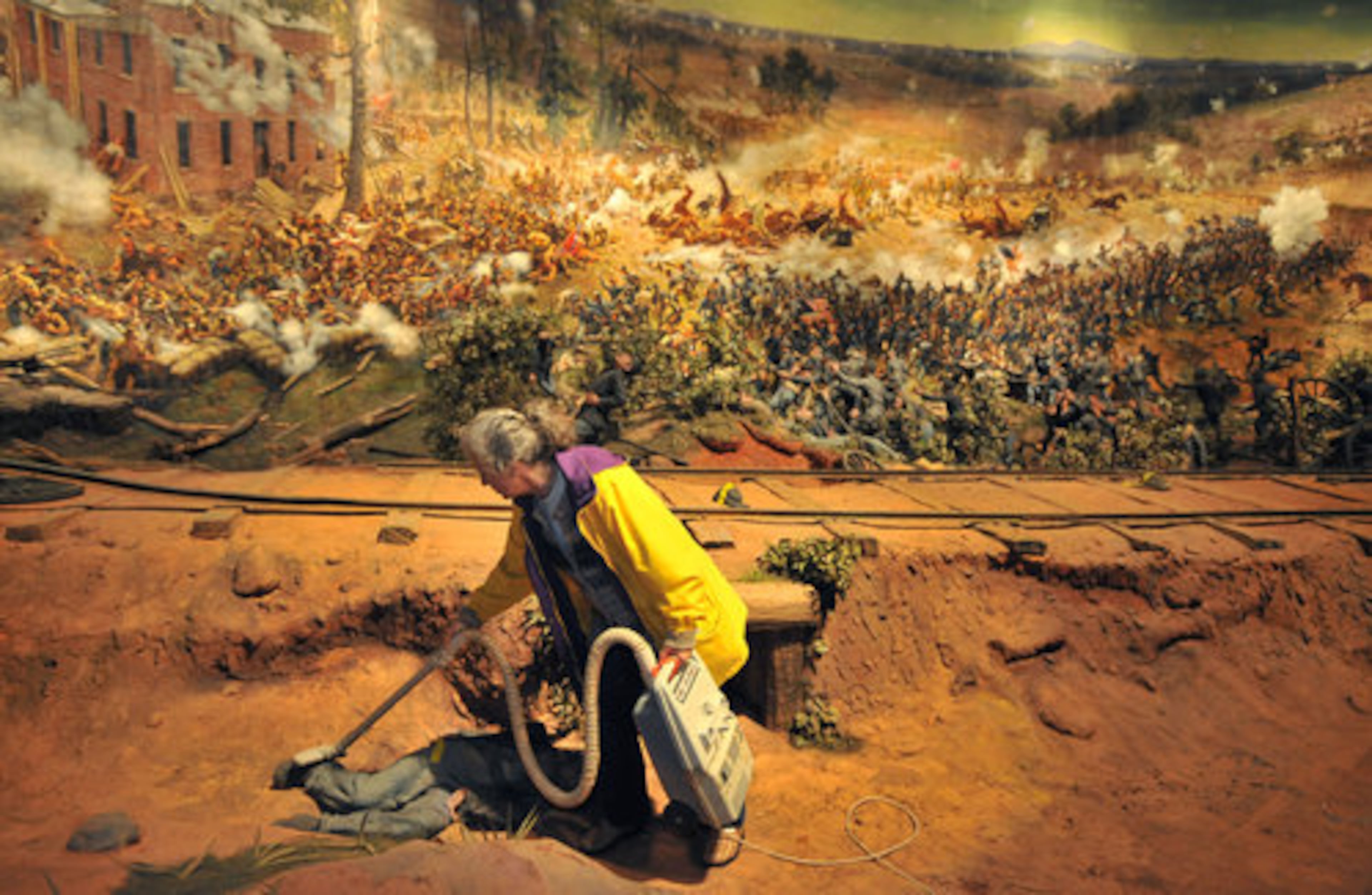 Volunteer Robbie Huck, of Marietta, vacuums the foot of a fallen soldier.