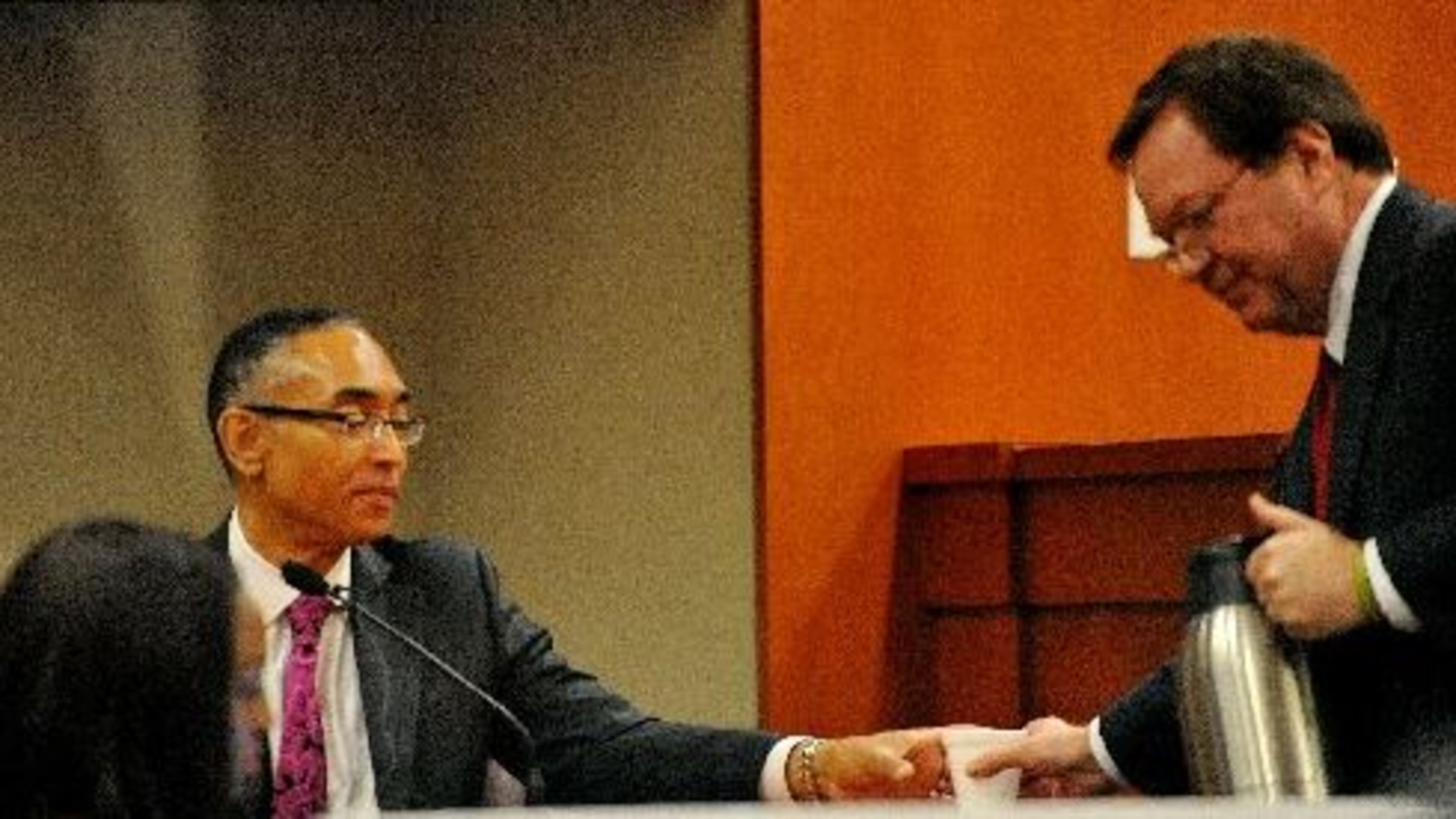 Burrell Ellis gets a drink of water from defense attorney Craig Gillen as he continues his testimony for a second day Friday. KENT D. JOHNSON /KDJOHNSON@AJC.COM