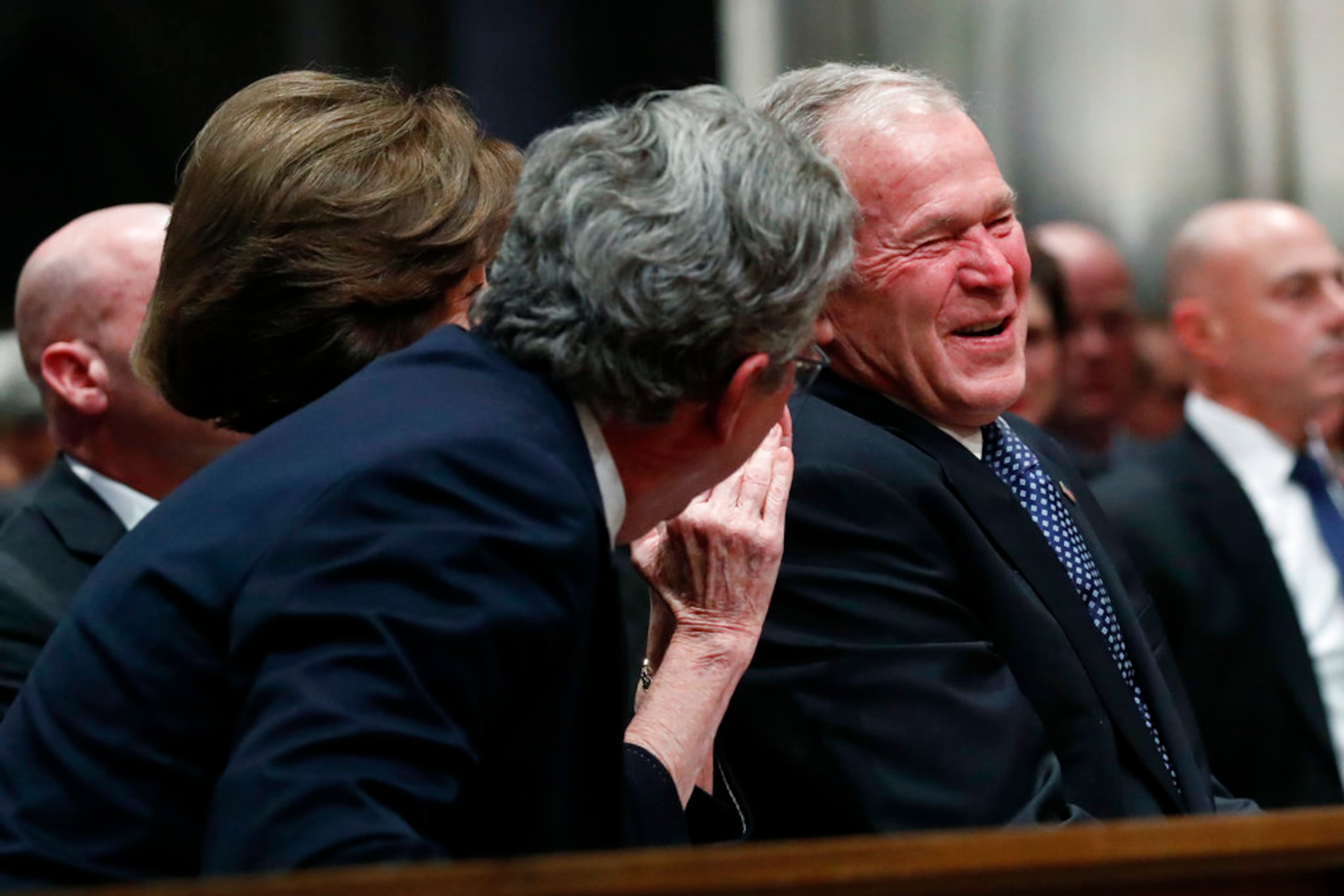 Former President George W. Bush smiles with his brother Jeb Bush and Laura Bush, center, at the State Funeral for their father, former President George H.W. Bush, at the National Cathedral, Wednesday, Dec. 5, 2018, in Washington. (AP Photo/Alex Brandon, Pool)