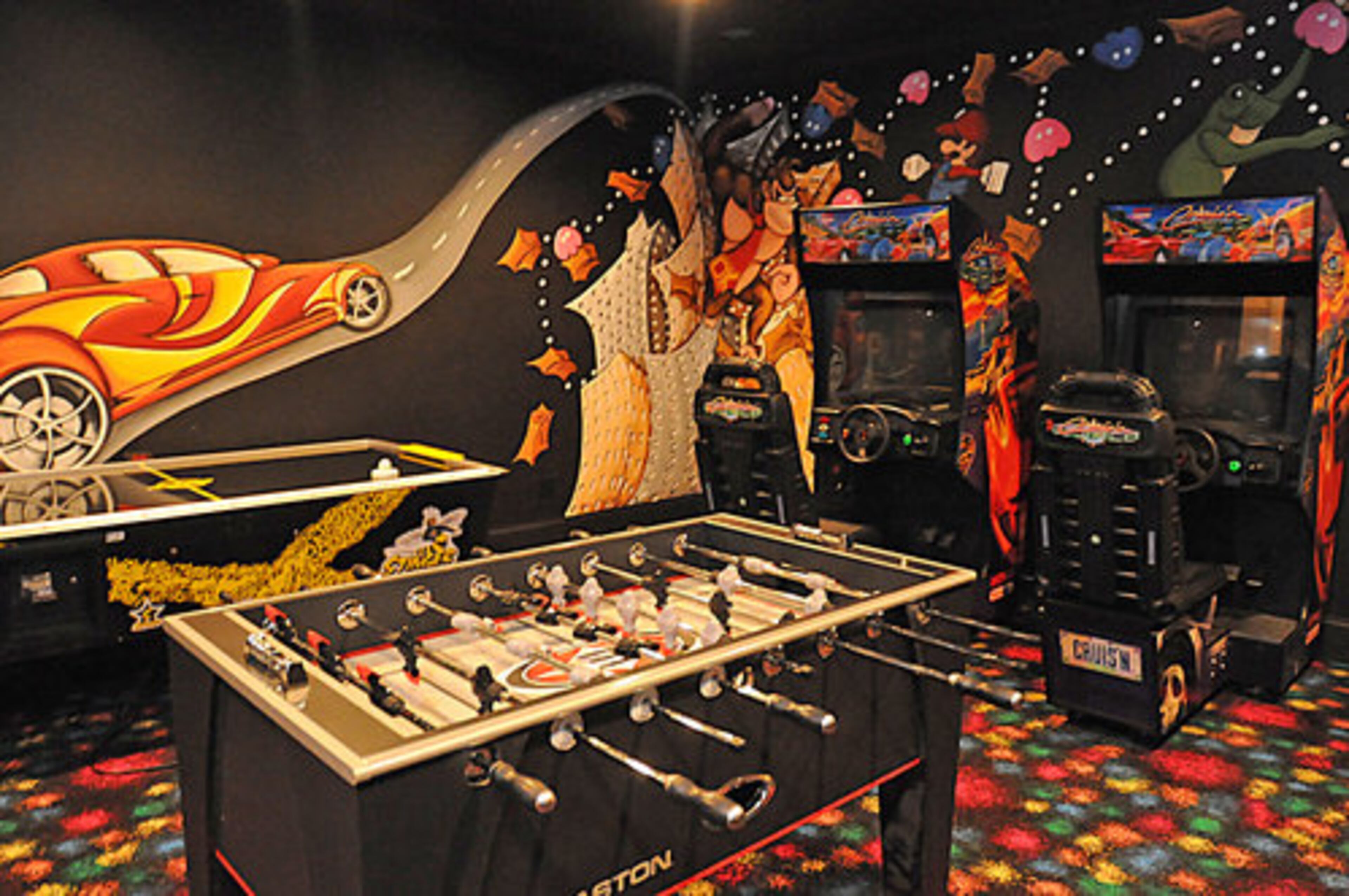 The arcade room is popular with the kids and adults alike. The colorful carpeting and original art on the wall only adds to the jovial mood of this room.