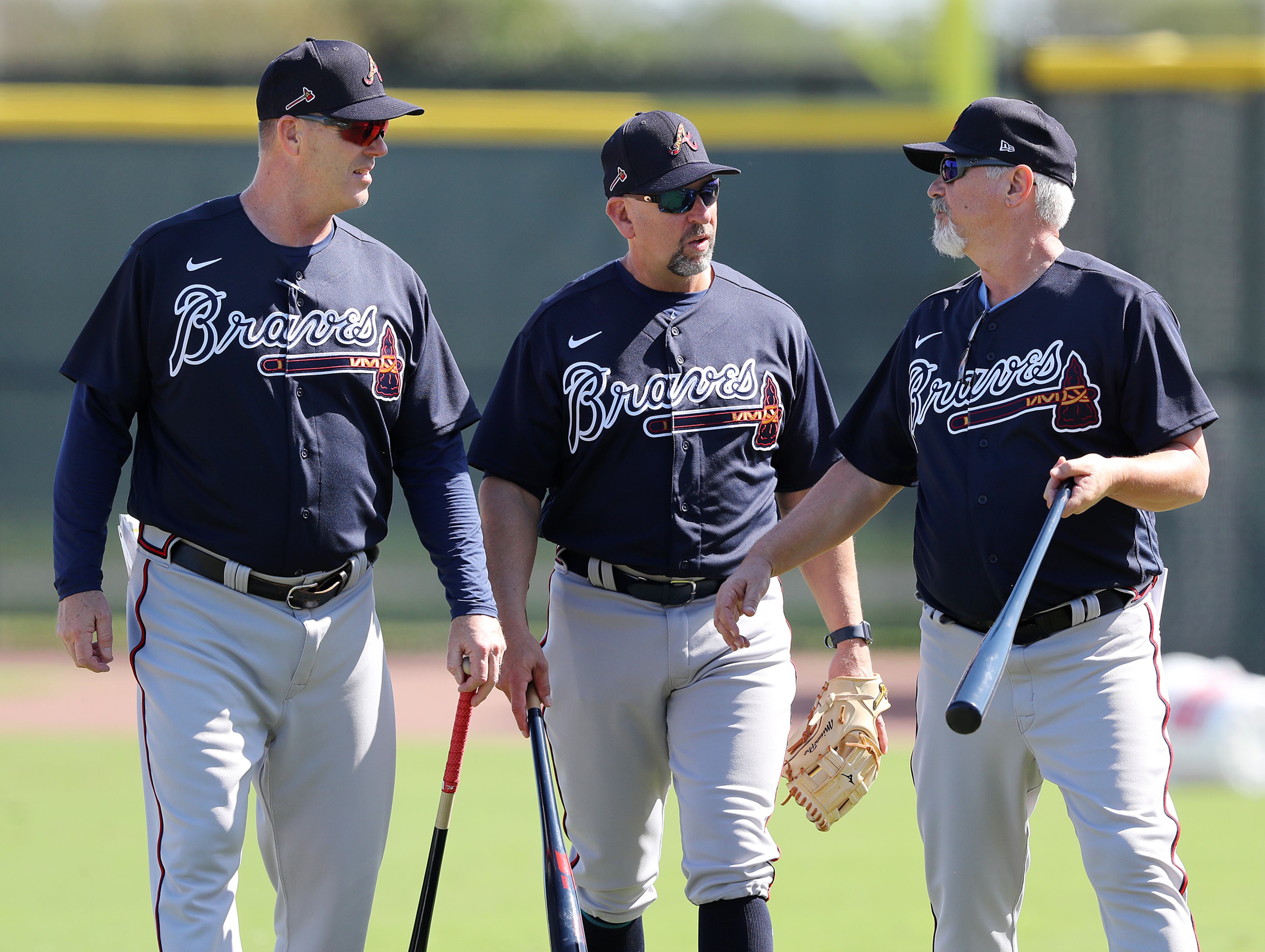 Braves coaches (from left) Marty Reed, Walt Weiss, and Rick Kranitz confer during spring training on Saturday, Feb. 15, 2020, in North Port. Curtis Compton ccompton@ajc.com