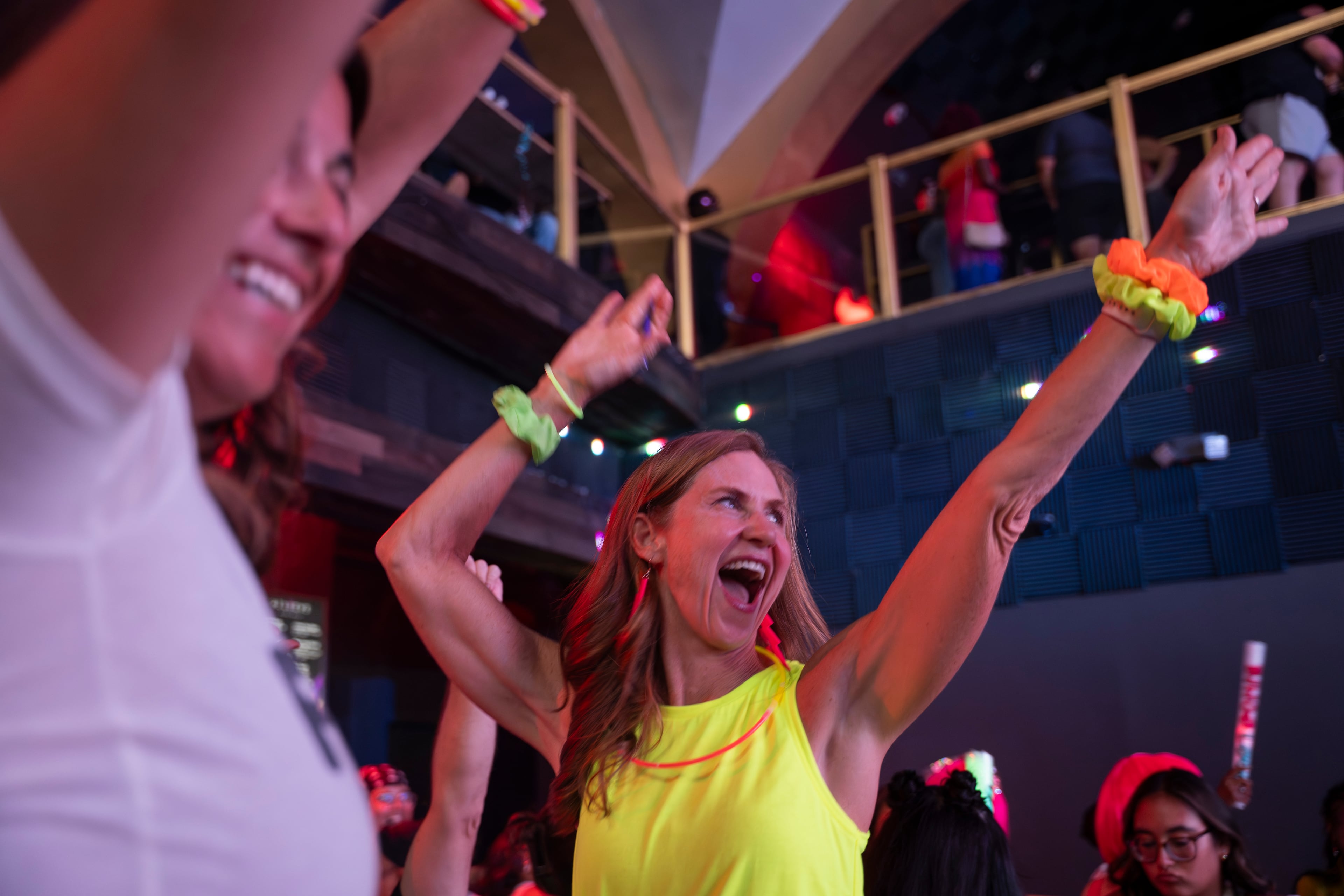 Sarah Joseph, right, at her first Bingo Loco, dances to "YMCA" with friend Adrienne Achey during the show at Believe Music Hall in Atlanta on Saturday, July 18, 2026. (Olivia Bowdoin for the AJC)