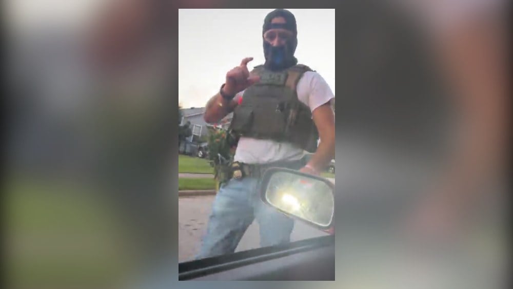 A masked immigration agent asks LaGrange resident Alex Orellana for identification in this screenshot taken from a livestream posted on Facebook on July 7. (Courtesy of Alex Orellana)