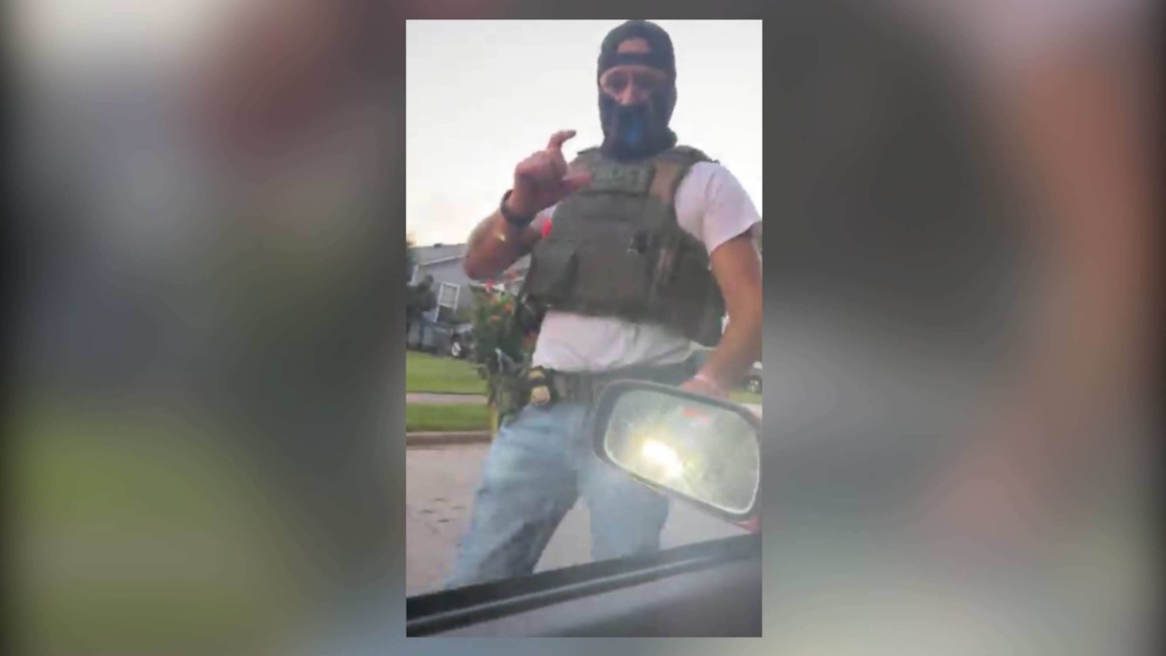 A masked immigration agent asks LaGrange resident Alex Orellana for identification in this screenshot taken from a livestream posted on Facebook on July 7. (Courtesy of Alex Orellana)