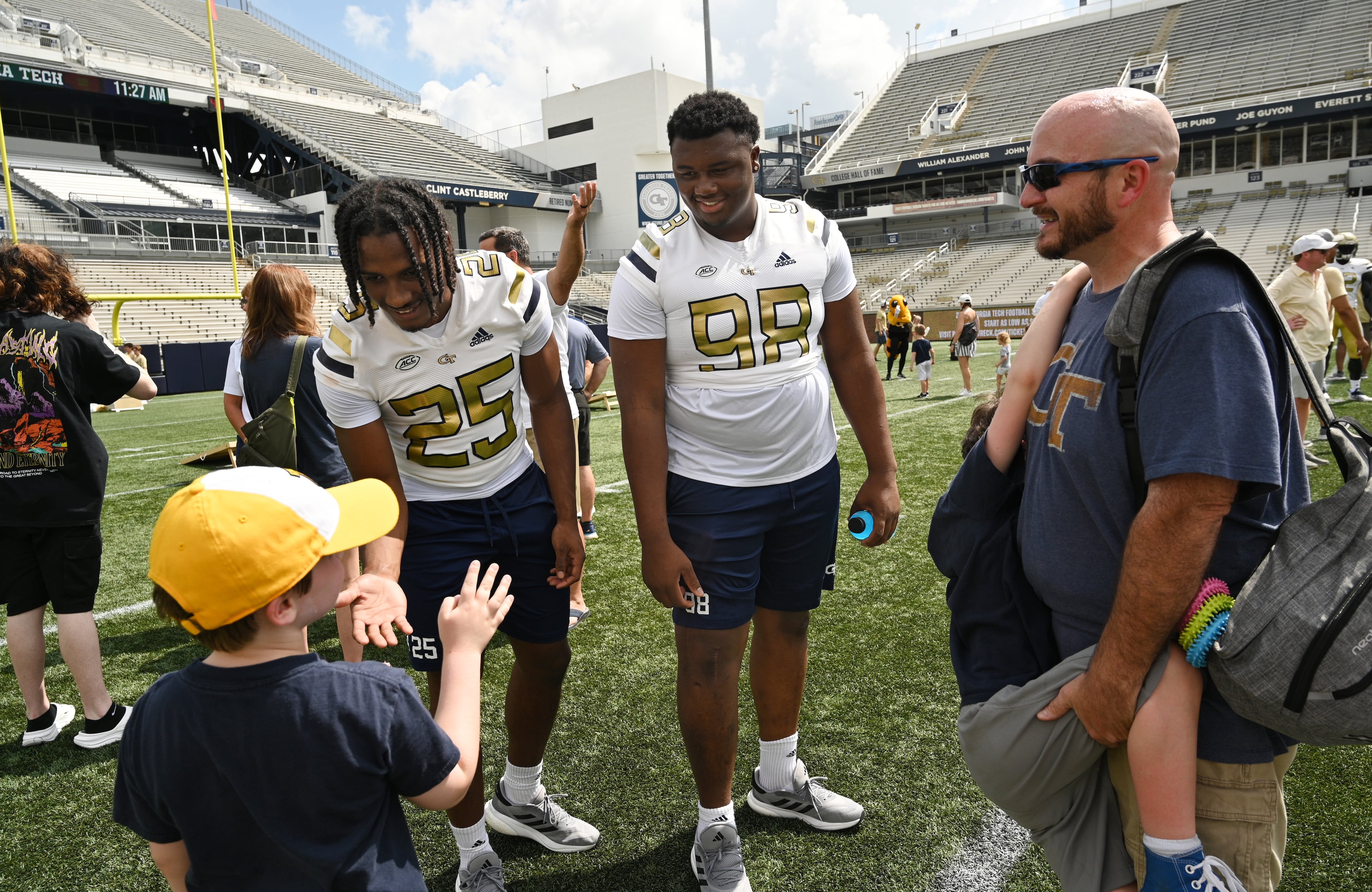 Georgia Tech freshmen defensive players Taye Seymore (25) and Bryston Dixon (98) greet fans. (Hyosub Shin / Hyosub.Shin@ajc.com)