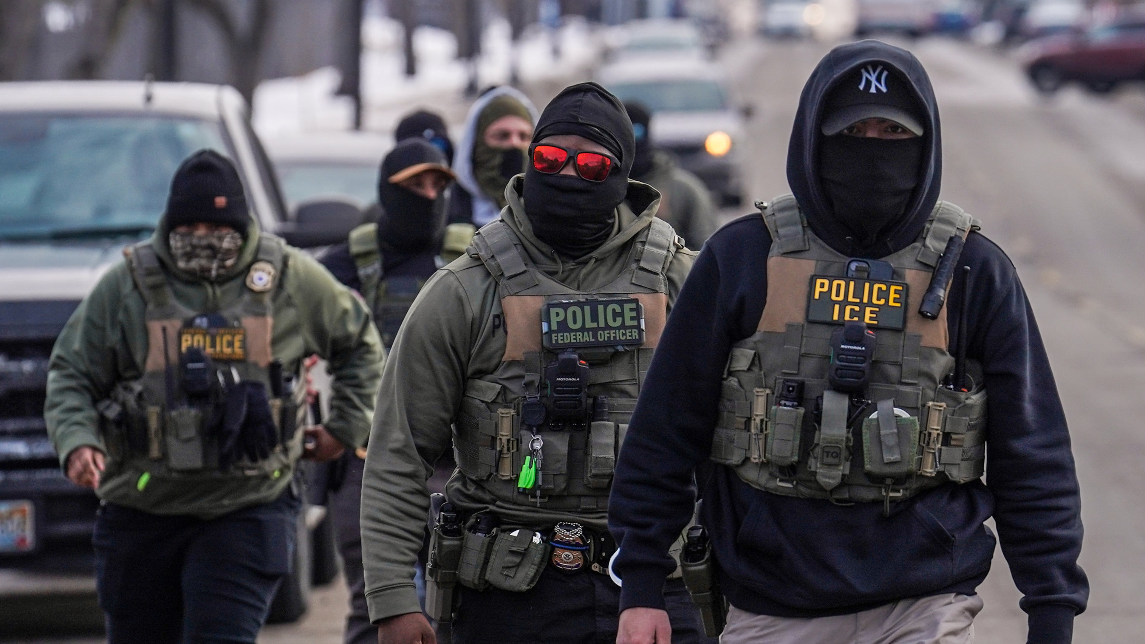 FILE - Federal agents walk down a street while conducting immigration enforcement operations in Minneapolis, Feb. 5, 2026. (AP Photo/Ryan Murphy, File)