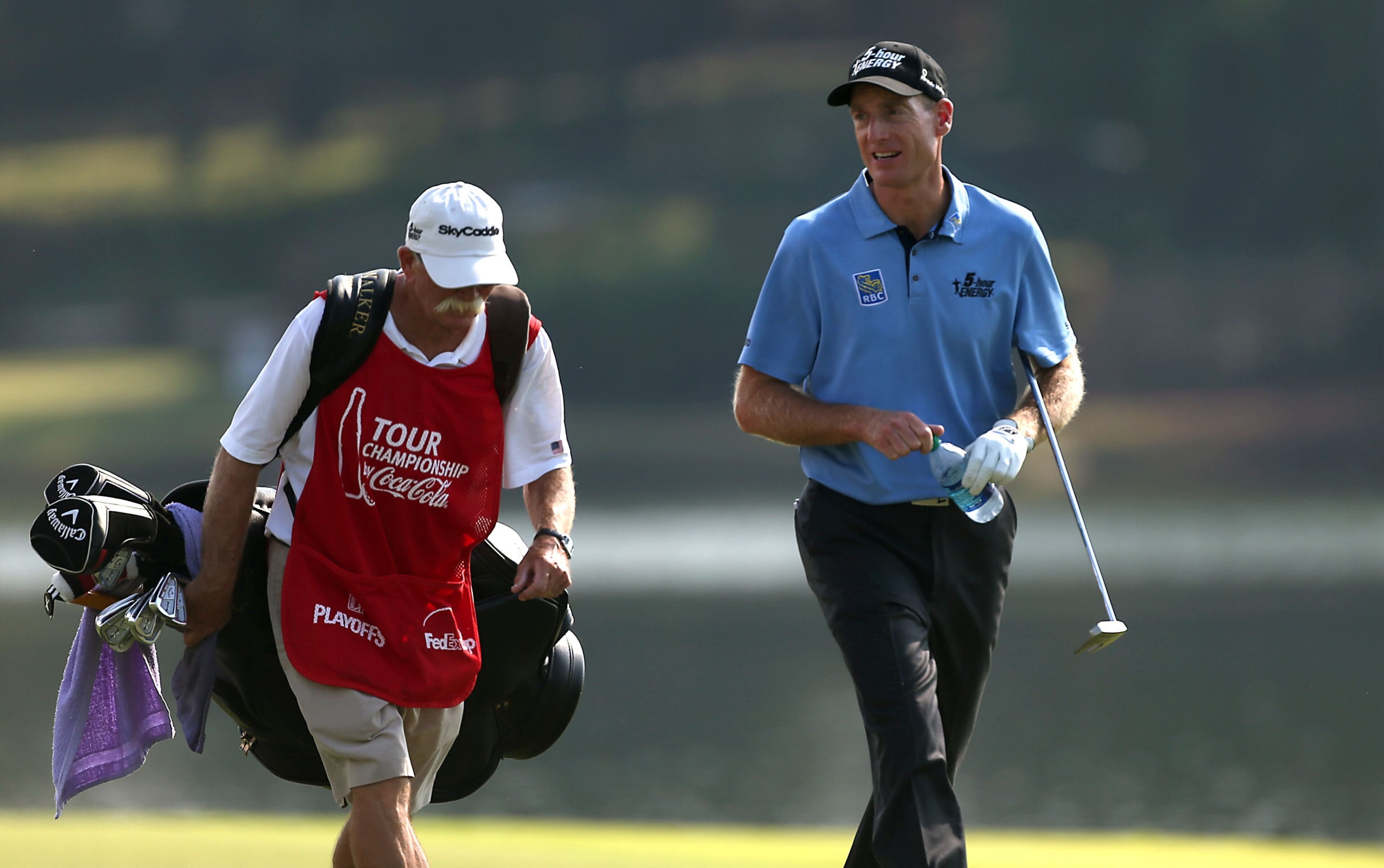 Jim Furyk walks with his caddie Mike 'Fluff' Cowan up the No. 17 fairway. Furyk had the lowest round of the day at 6-under 64 ....