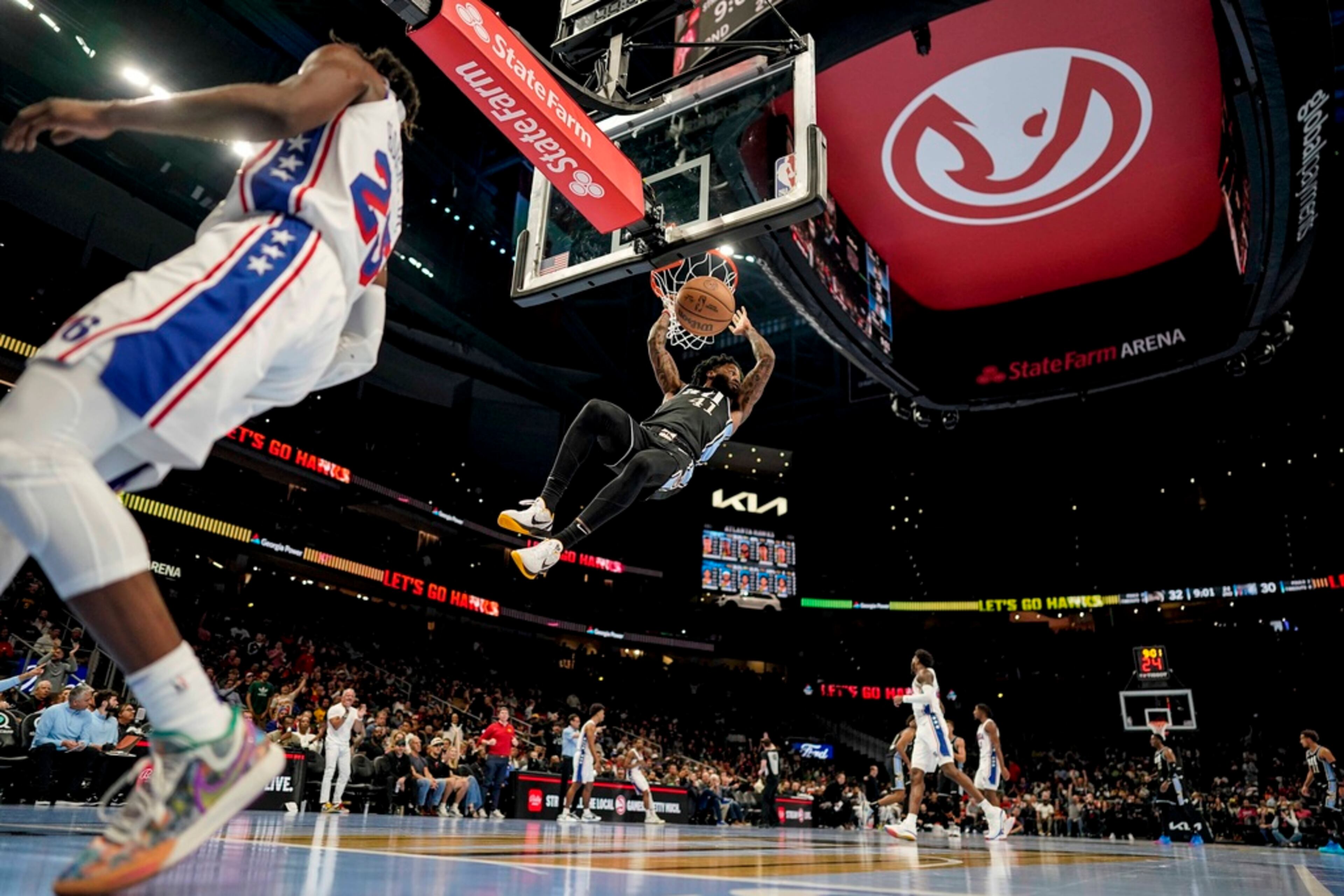 Atlanta Hawks forward Saddiq Bey (41) dunks the ball against Philadelphia 76ers forward Danuel House Jr. (25) during the first half of an In-Season Tournament NBA basketball game, Friday, Nov. 17, 2023, in Atlanta. The Hawks lost 126-116. (AP Photo/Mike Stewart)