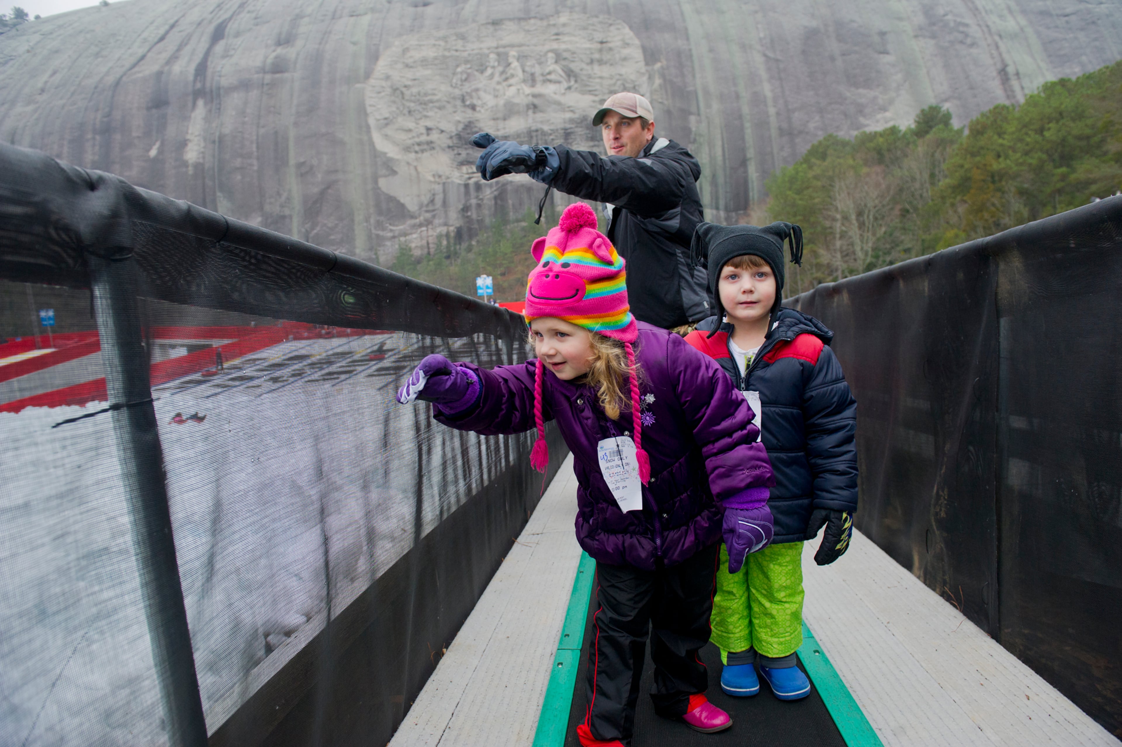 Asiya Khasnutdinova and mother, Svetlana get their picture made by father and husband, Lyusyen (all-CQ) in front of Santa Claus at Crossroads in Stone Mountain Park where the park is celebrating its Stone Mountain Park Christmas. (FILE)